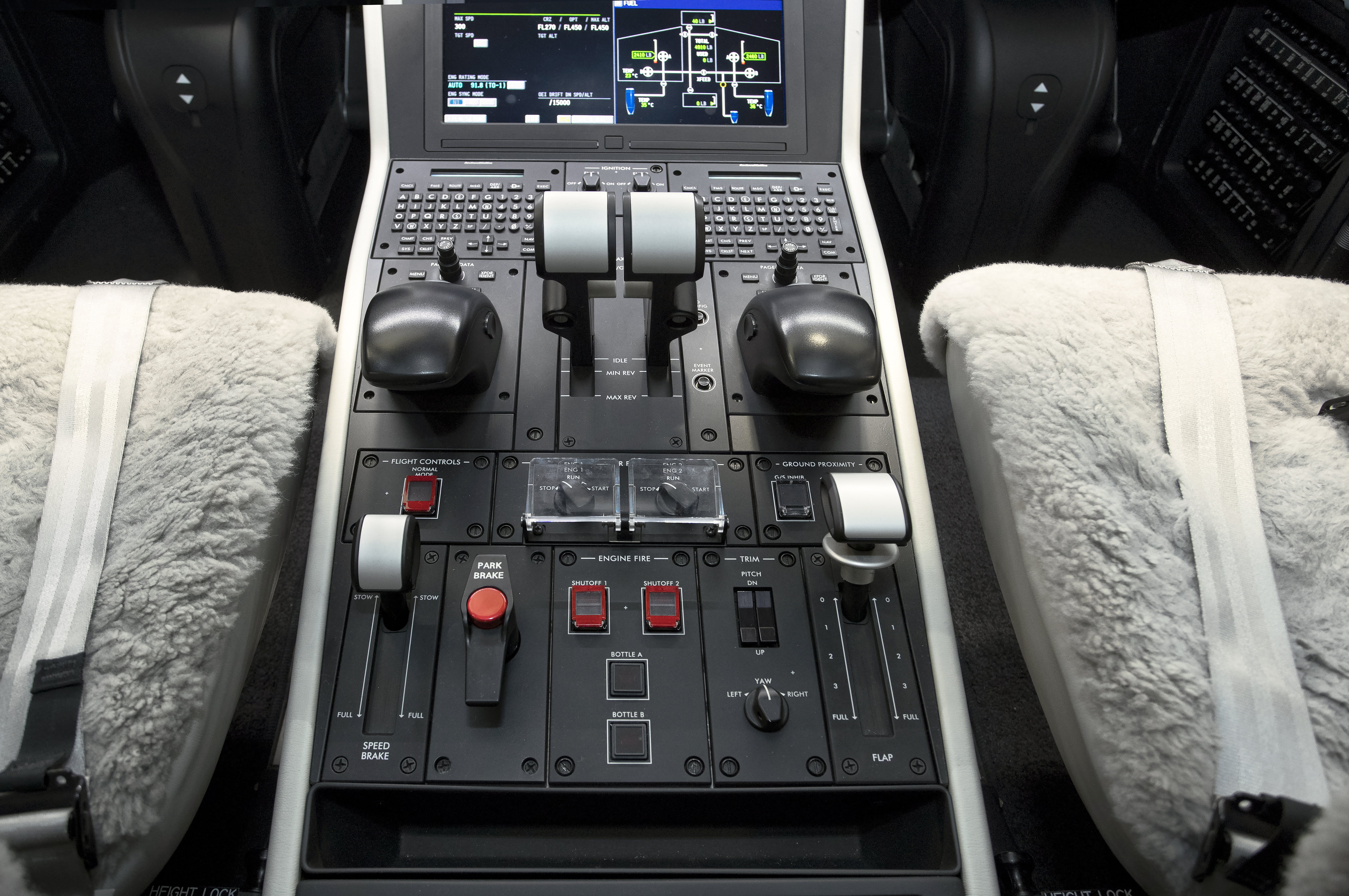 The cockpit center pedestal has, from the top, FMS keypads, thrust levers, and cursor control devices. The airplane has a ram air turbine (RAT) that can power the ship in the unlikely event of a complete electrical failure.