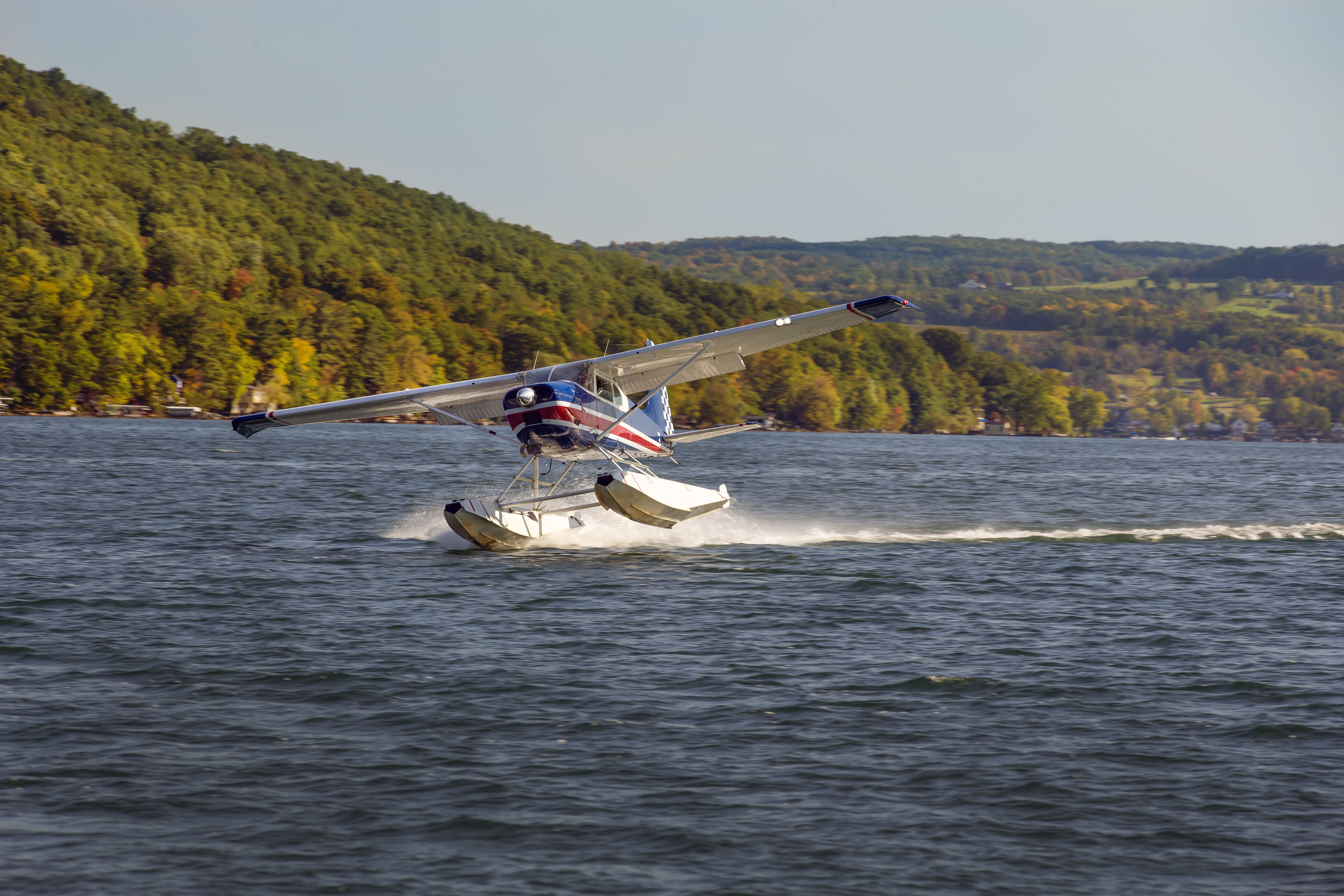 Local pilot Rob Kinyoun skims Keuka Lake in his Cessna 180.