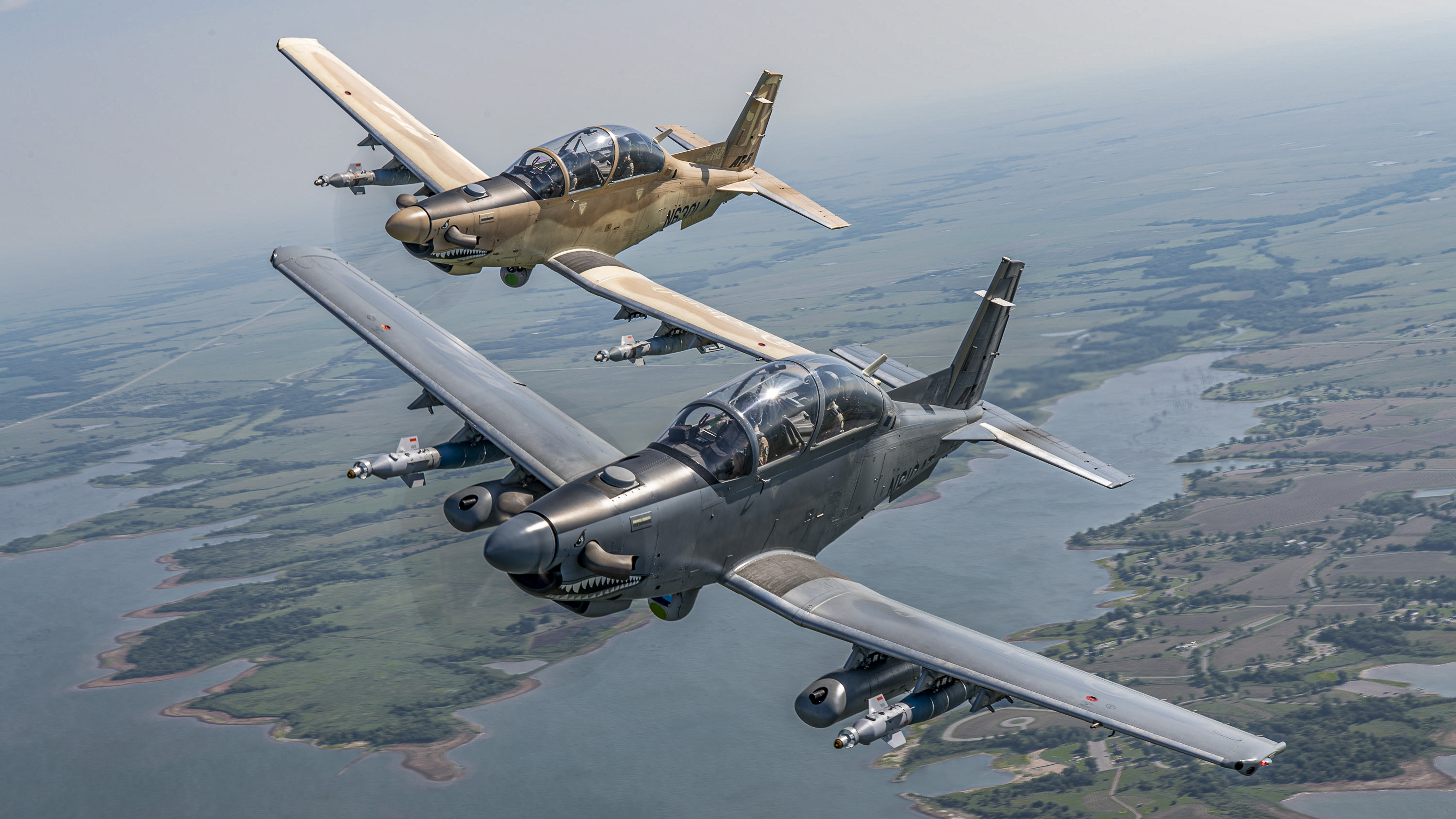 Two armed Wolverines fly in close formation. Those are satcom antennas on top of the cowlings. (Courtesy Textron Aviation)