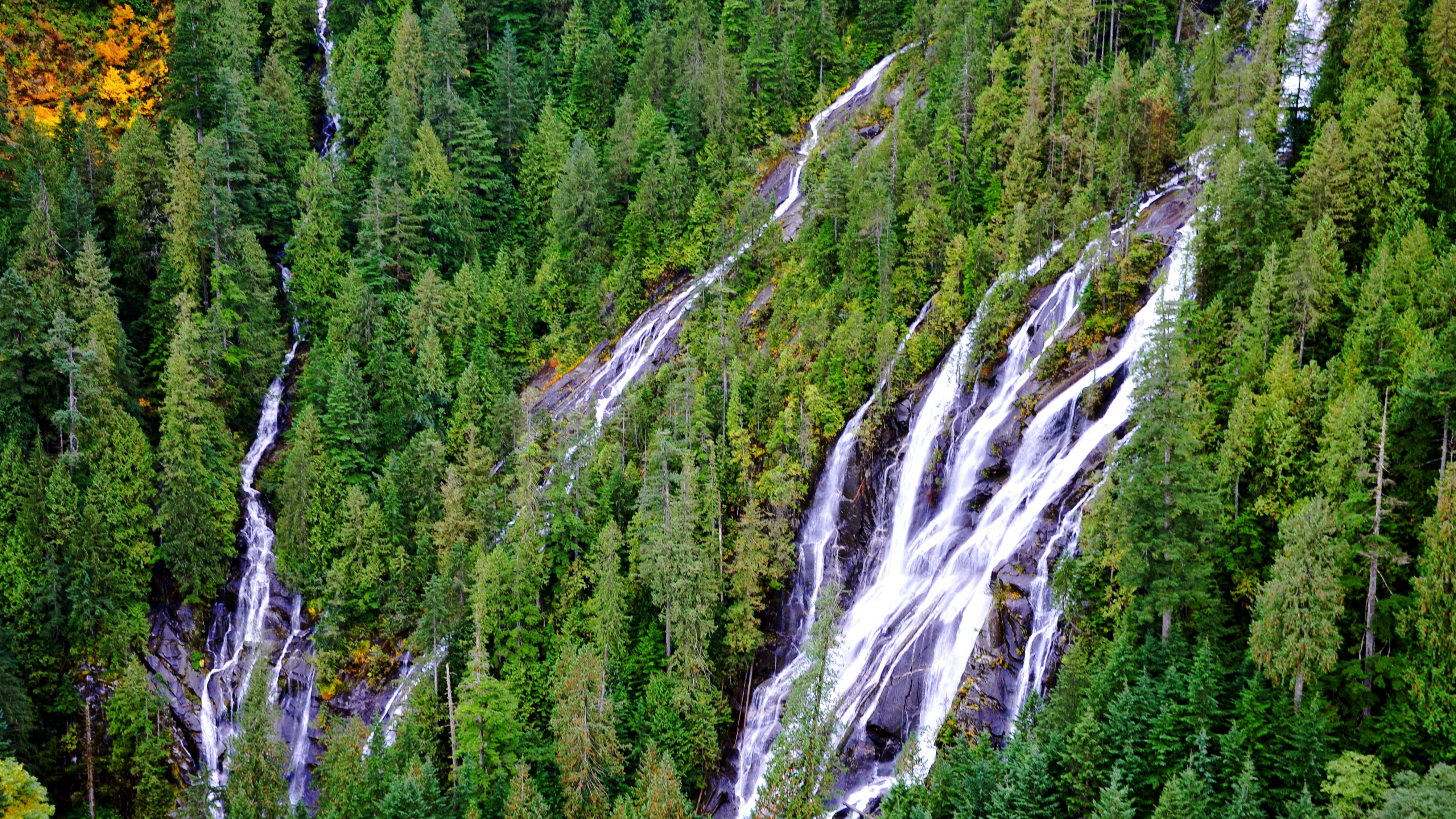 BRIDAL VEIL FALLS, LAKE SERENE, MOUNT INDEX, WASHINGTON: 'Bridal Veil Falls is located on the north side of Lake Serene at the base of Mount Index. I took this from my Cessna 182 while taking photos of the fall colors around Puget Sound and western Washington. I love the lush green forest and touches of fall color as the water comes off Lake Serene, creating these beautiful falls.'