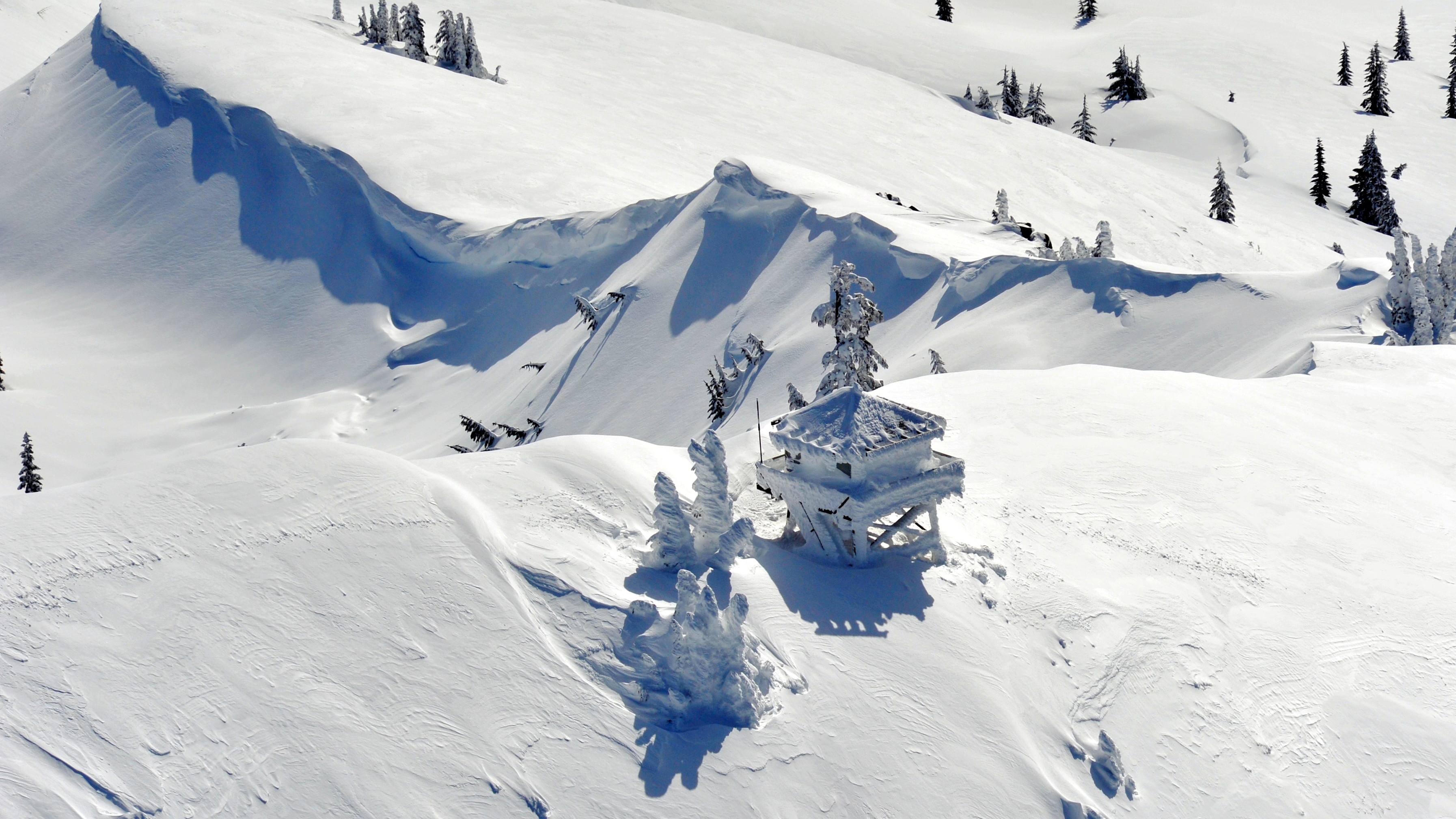 GRANITE MOUNTAIN LOOKOUT, CASCADE MOUNTAINS, WASHINGTON: 'Granite Mountain Lookout is located near Snoqualmie Pass and north of Interstate 90 at 5,629 feet. It was another one of those beautiful winter flying days, so I decided to fly the Cessna 182 over the Overcoat Peak and Chimney Rock. I flew around this area for about 40 minutes before flying over Snoqualmie Pass and toward Granite Mountain. I made several passes over the lookout, hoping to get some good shots with the heavy snow.'