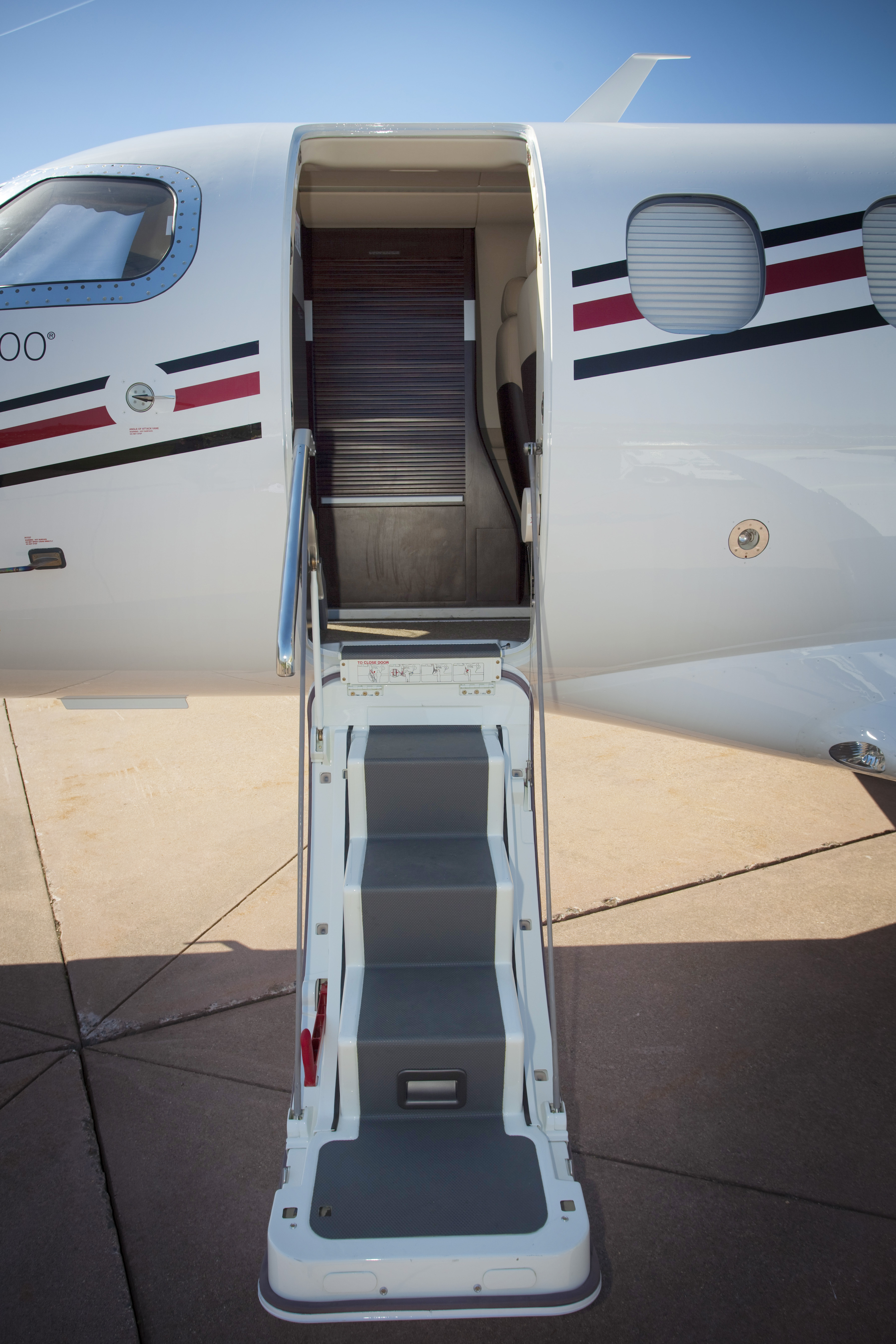 Embraer Phenom 100: A Phenom 100 shows off a must-have high-end feature; an airstair door. 