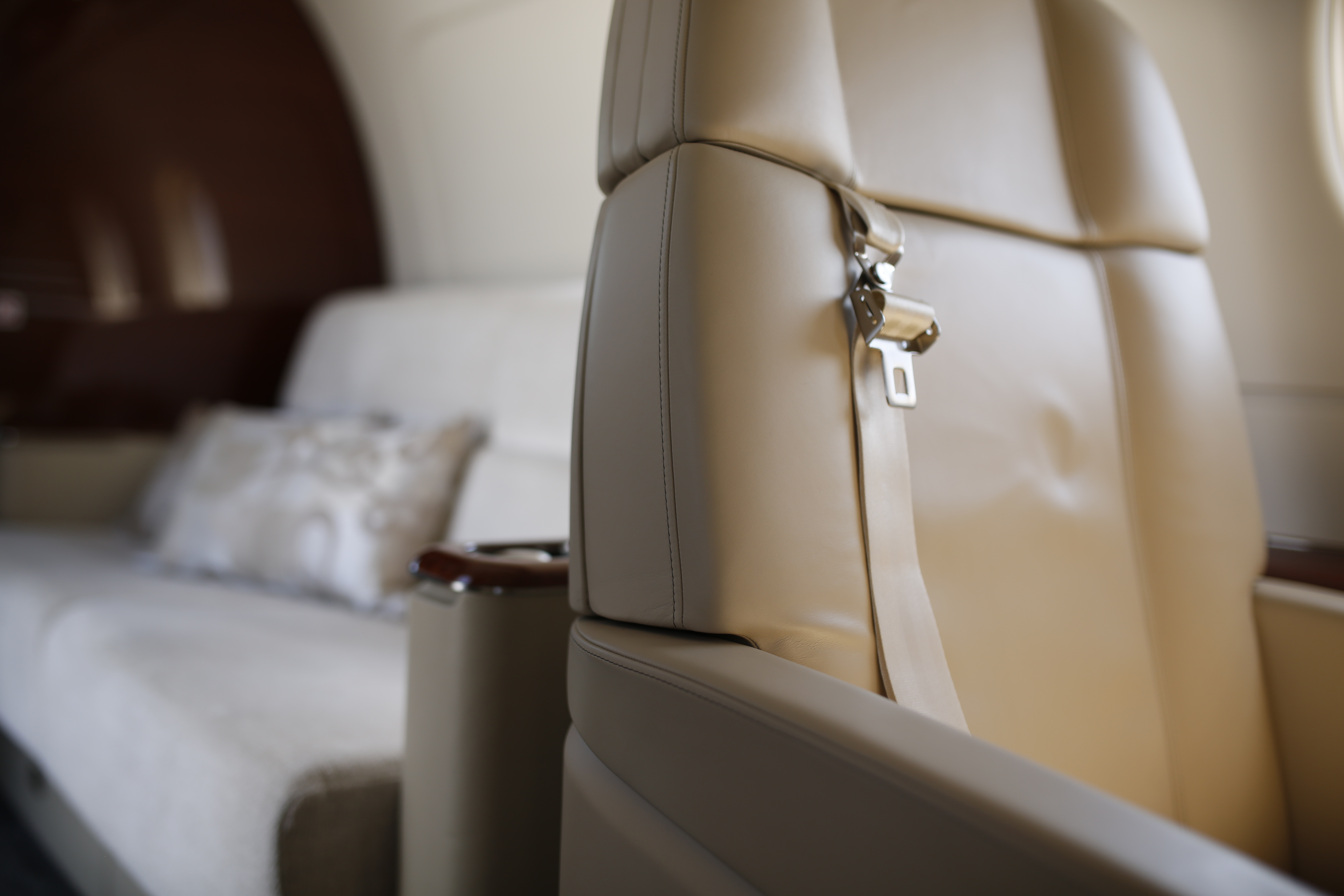 Optimal seat design takes in the angles between the seat and seat back (Embraer Legacy 450), the dimensions of the thigh support upholstery, the curvature of the lumbar support and seat back, the amount of thoracic support, the size and positioning of the arm rests, and the distance between the base of the seat and the floor. 