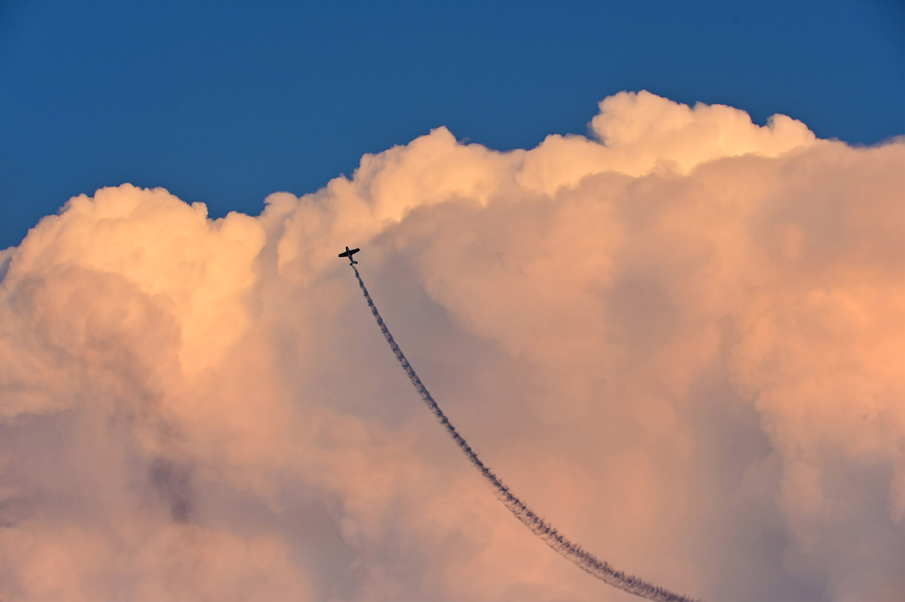 “AirVenture Highlighted by Celebration, Innovation”: Airshow performer Julie Clark flies her Beech T-34 Mentor into the sunset for the last time during an EAA AirVenture 2019 performance that signaled her retirement after 40 years and 34,000 hours in her logbook. Clark’s smoke trail splitting clouds that are illuminated with pastels from a setting sun seemed a poignant end to a brilliant airshow career. (Nikon Z6, 122mm, 1/320, f7.1)