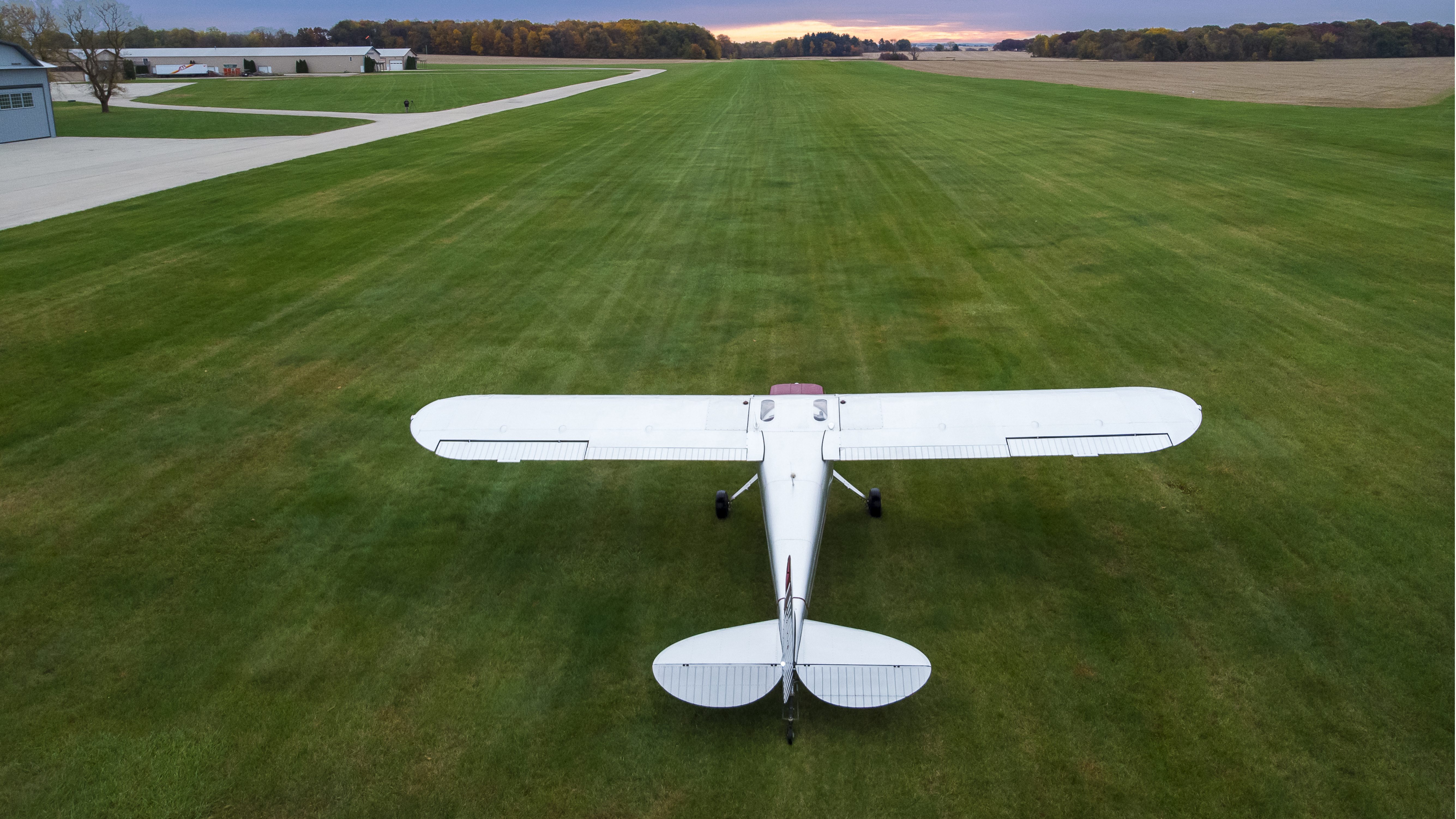 AOPA's Kollin Stagnito Cessna 120 plays on the grass at Poplar Grove Airport.