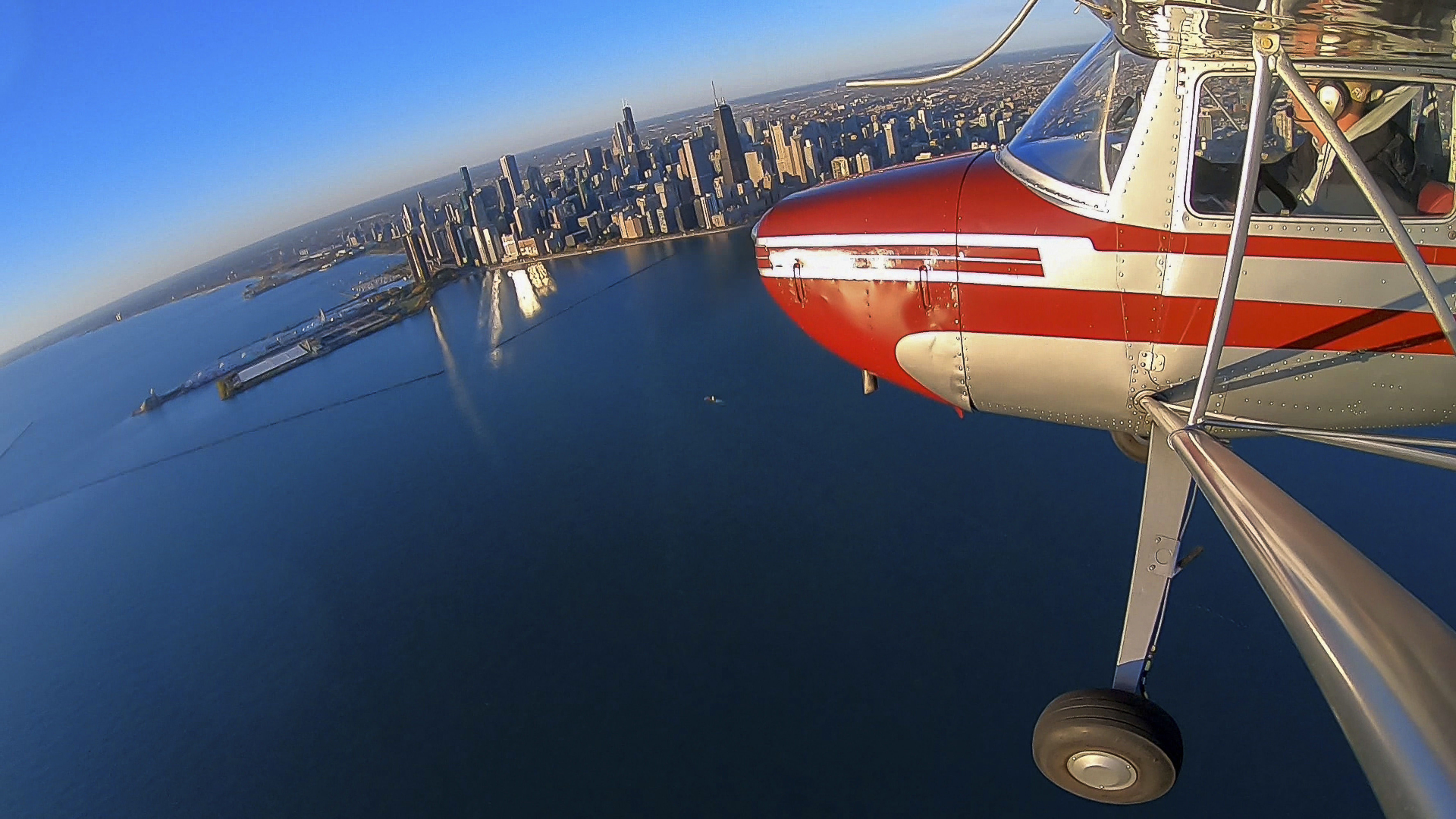A Cessna 140 tours the Chicago skyline.