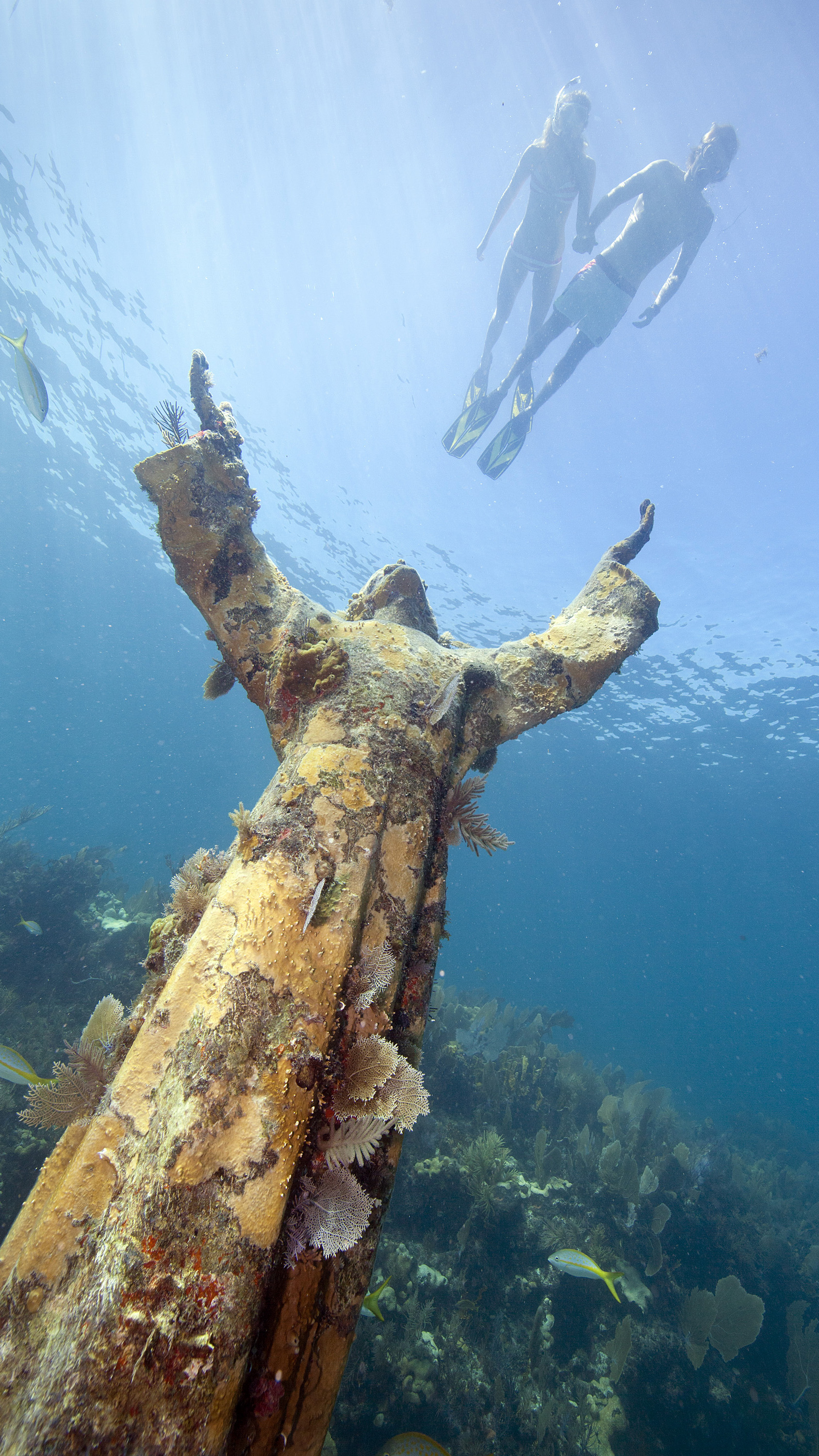 Snorkelers glide over the Christ of the Abyss statue in the Florida Keys National Marine Sanctuary off Key Largo. Courtesy keys.com, Stephen Frink