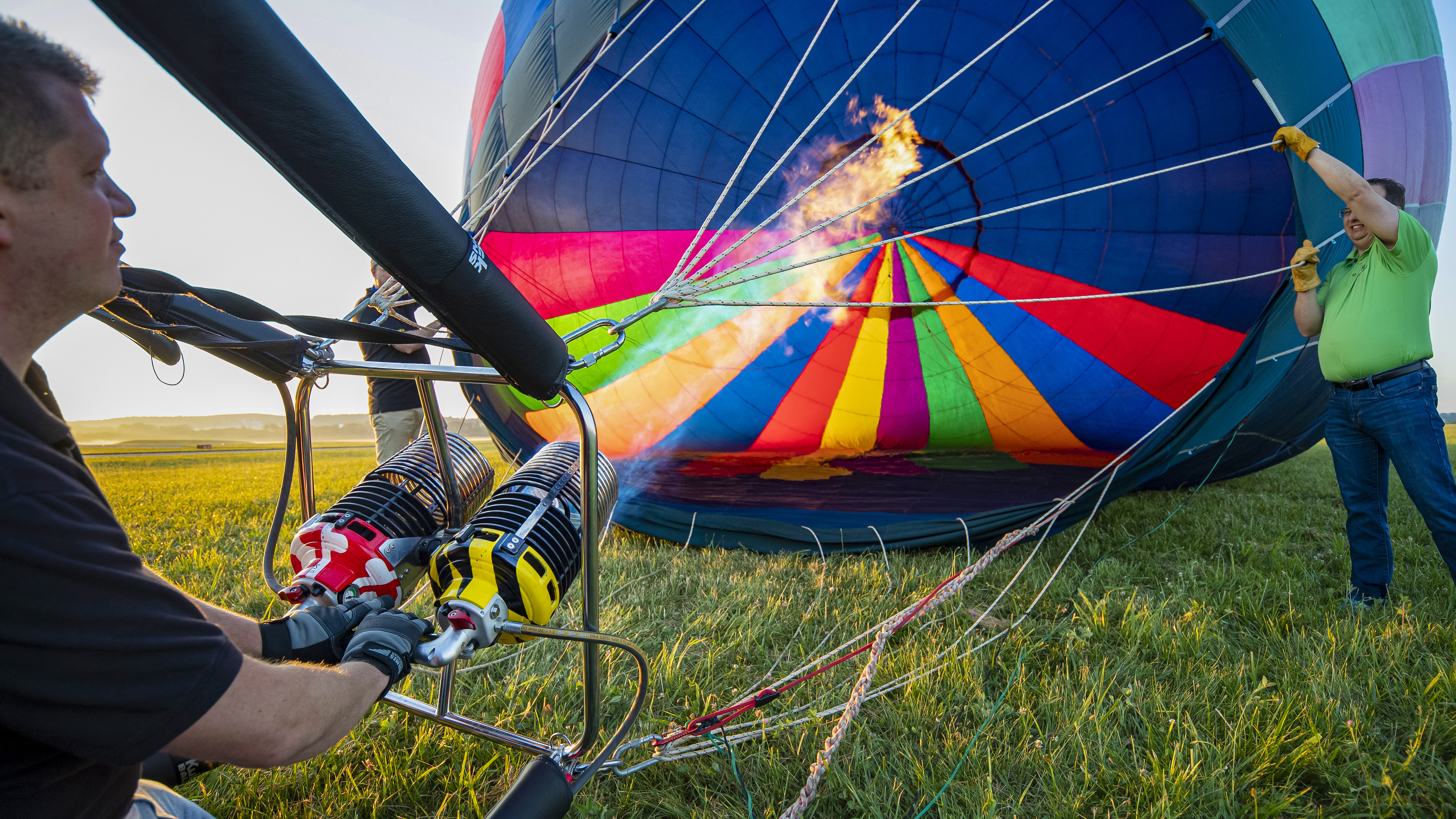 Ground crew are an integral part of balloon flying. Keith Kern (green shirt) holds the mouth of the balloon steady while Patrick Smith fires the burners to heat the air.