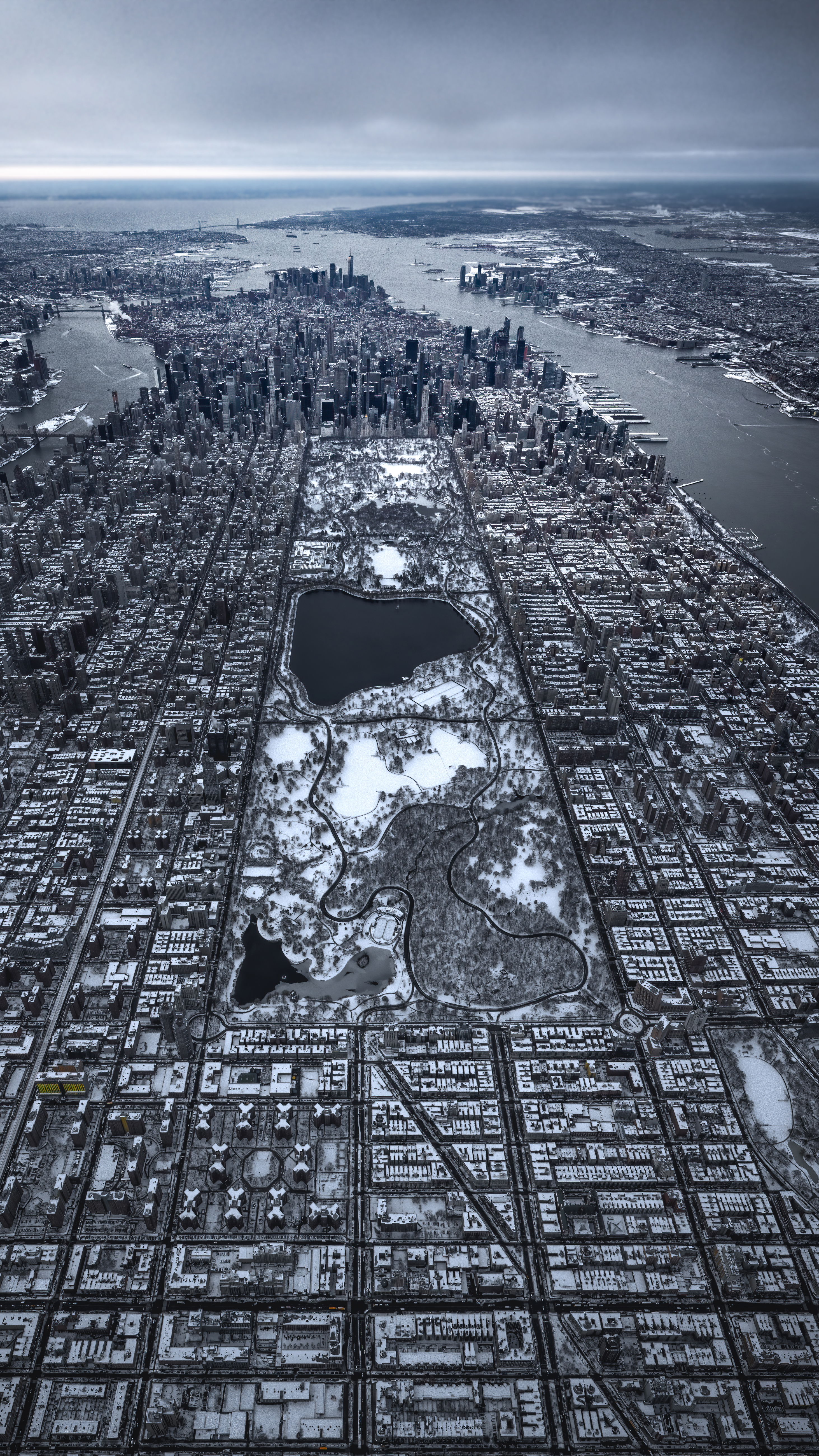 Snow in Central Park. This was shot from a Bell 206 LongRanger between 5,000 and 5,500 feet above the city looking south from Harlem."This was in December 2020, the day after our first big snowstorm in a number of years. For me, the snow scene from this vantage point is remarkable because you can see the grid and the city planning aspect of Manhattan. The black of the asphalt contrasted with the white of the snow makes it looks like a microchip or a computer motherboard."