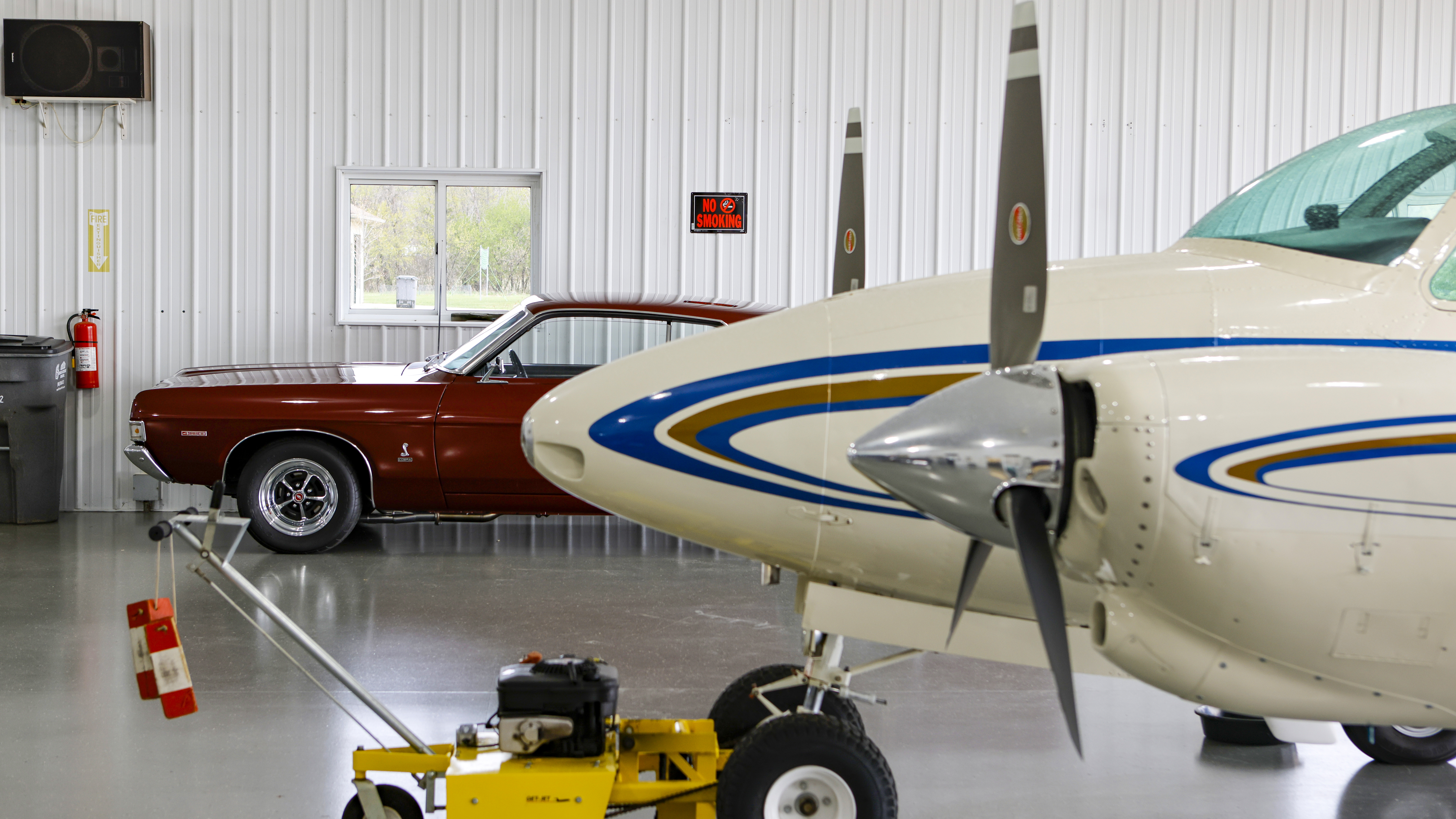 That’s a 1969 Ford Fairlane Cobra against the far wall behind the Travel Air.