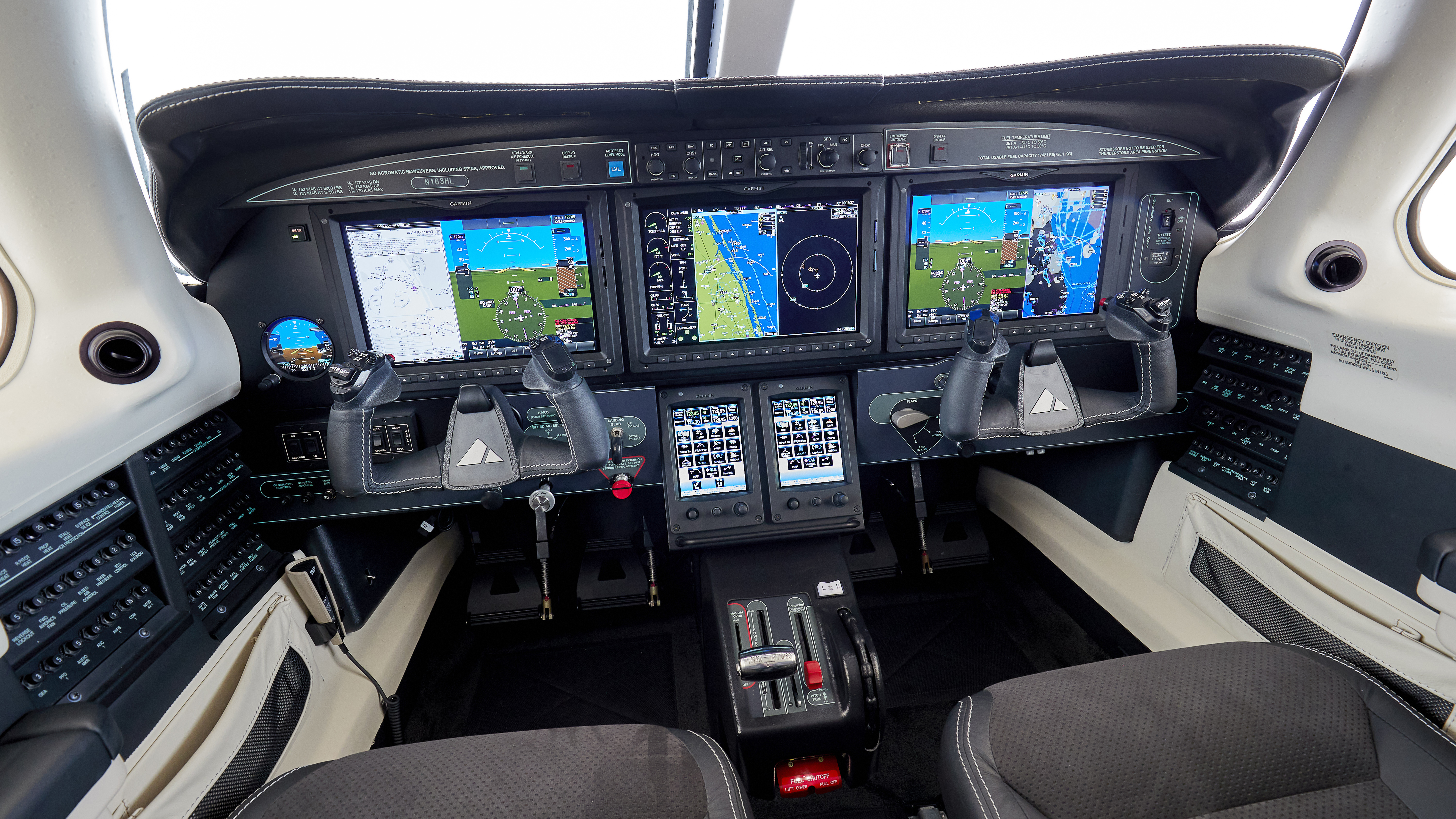 The G3000’s three display screens can be split, giving the pilot views of up to six different sources of information. Note the glareshield’s blue Level button. Pressing it automatically returns the airplane to a straight and level attitude.