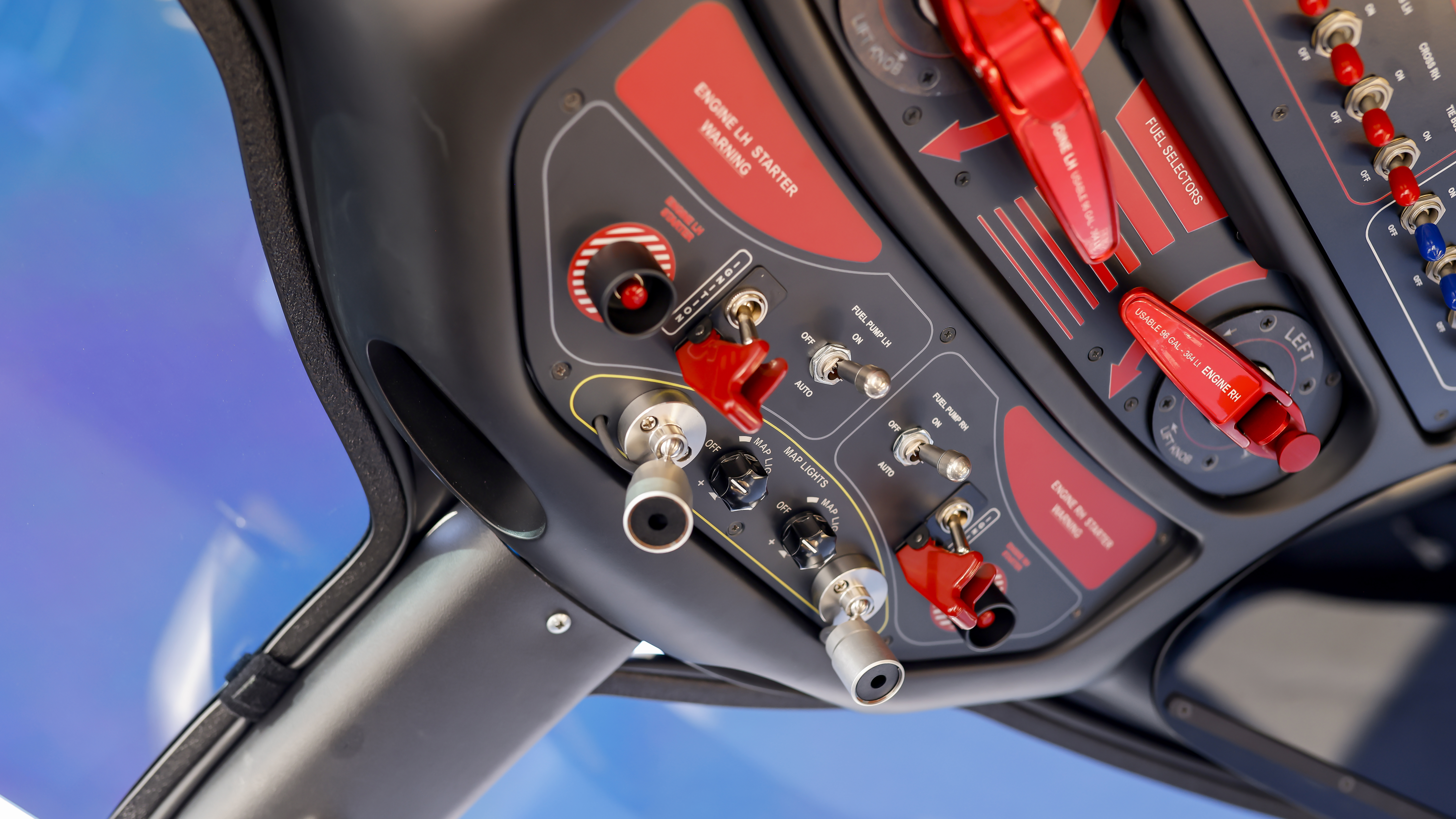 The overhead panel includes fuel valves, ignition switches, and pushbutton engine-start switches.