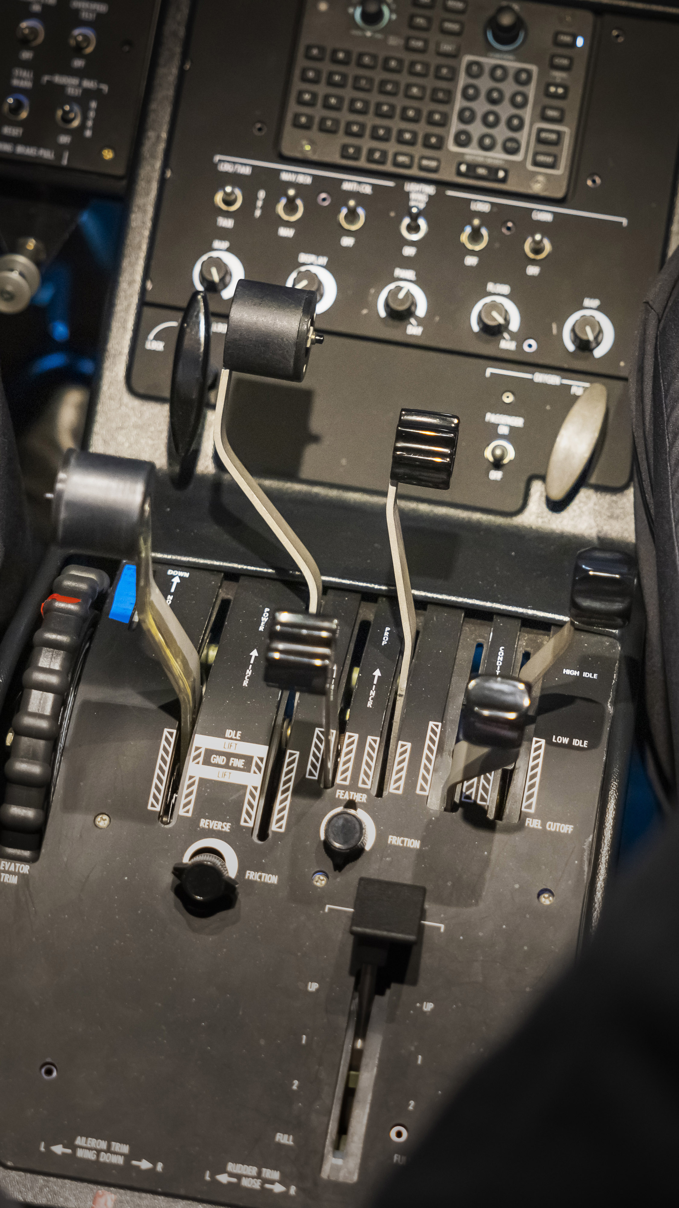 The power quadrant, showing the left propeller feathered and its engine shut down.