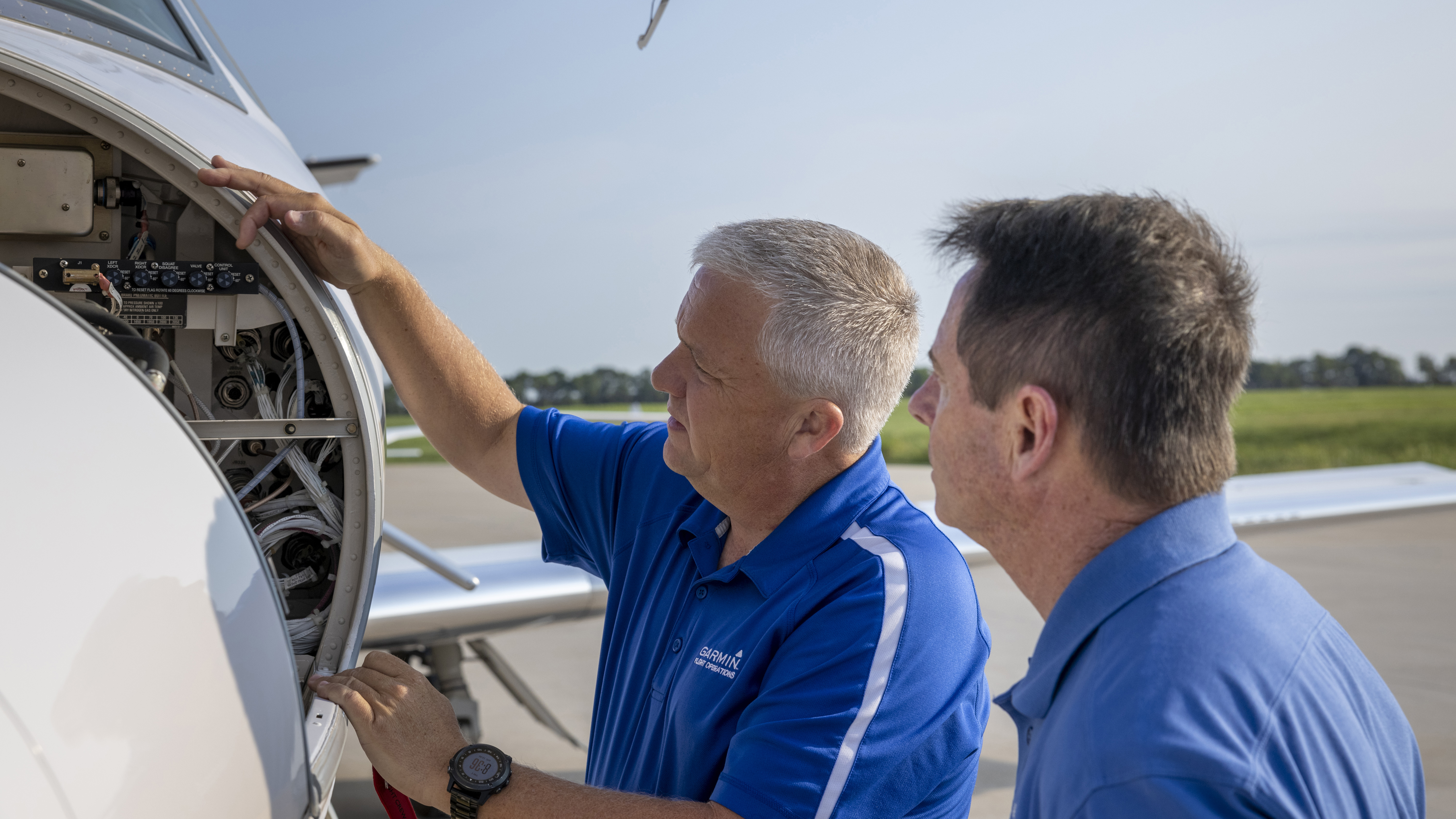 Garmin Flight Test Pilot Scott Wheeler (left) shows the author the nose avionics bay, which is far less cluttered than when the original Excel left the factory with its 1990s-era cockpit.