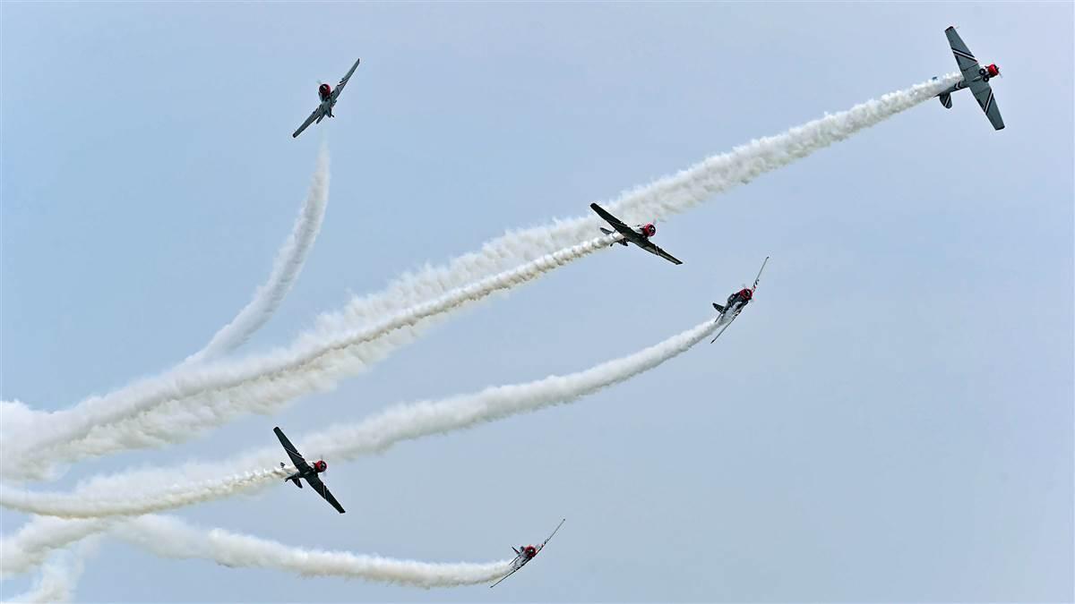 The Geico Skytypers perform a breakaway during the opening day’s afternoon airshow at EAA AirVenture. Photo by David Tulis.