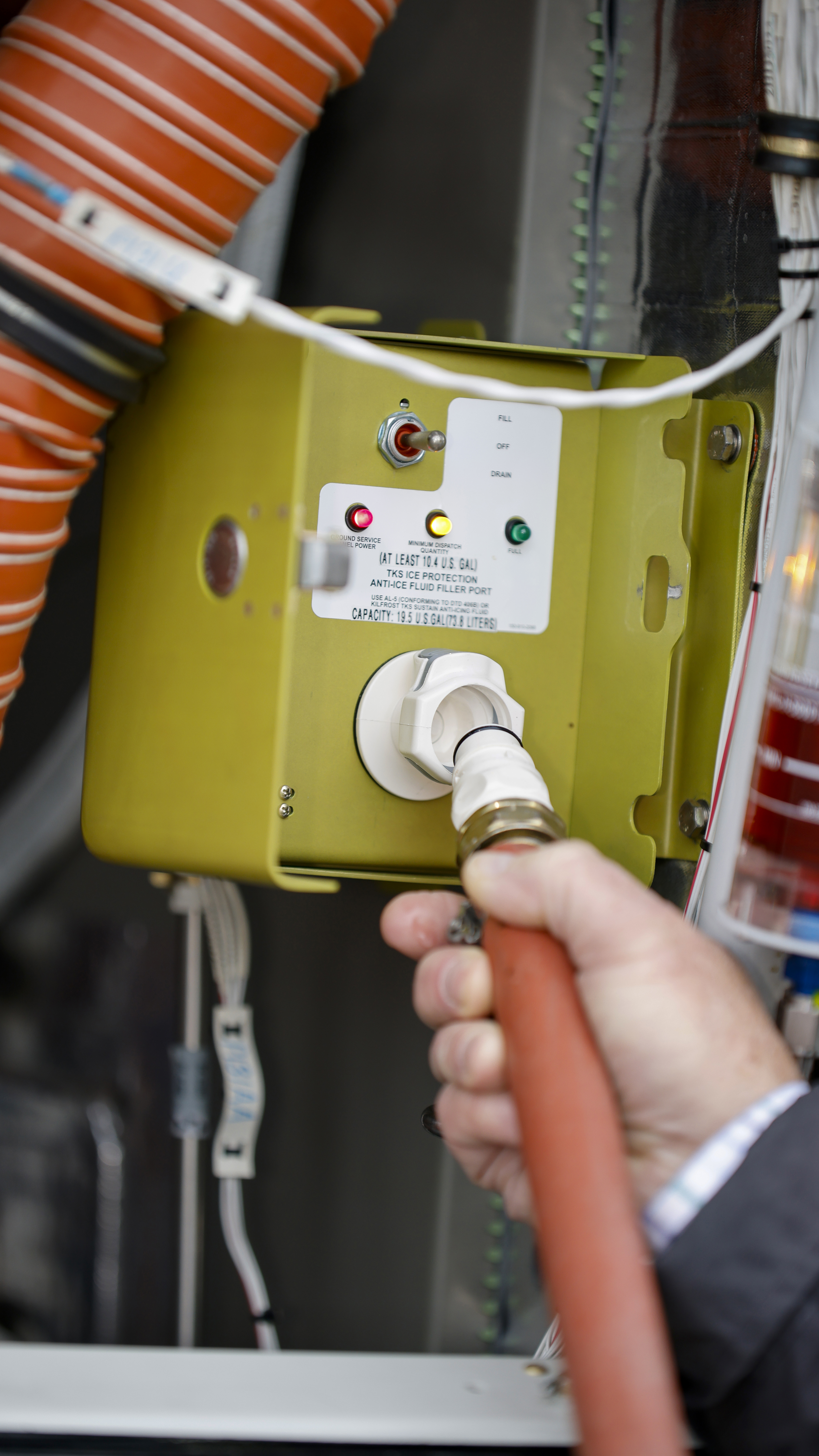 Inside the engine compartment is the new auto fill controller for the TKS fluid. The pilot selects the amount desired, connects the hose to the controller, and puts the other end into a container of fluid.