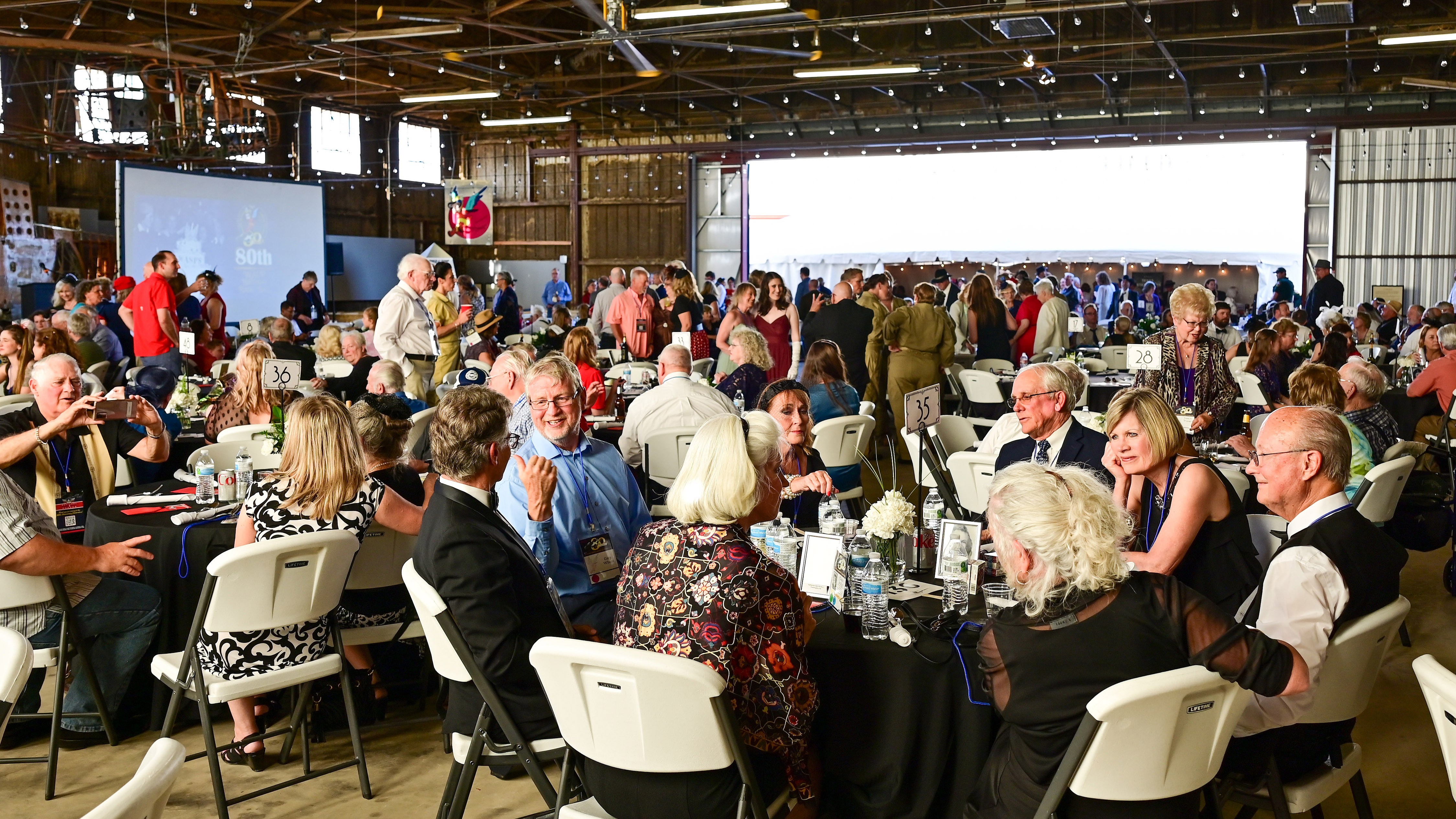 WASP friends and family members socialize at a hangar dance during the eightieth homecoming.