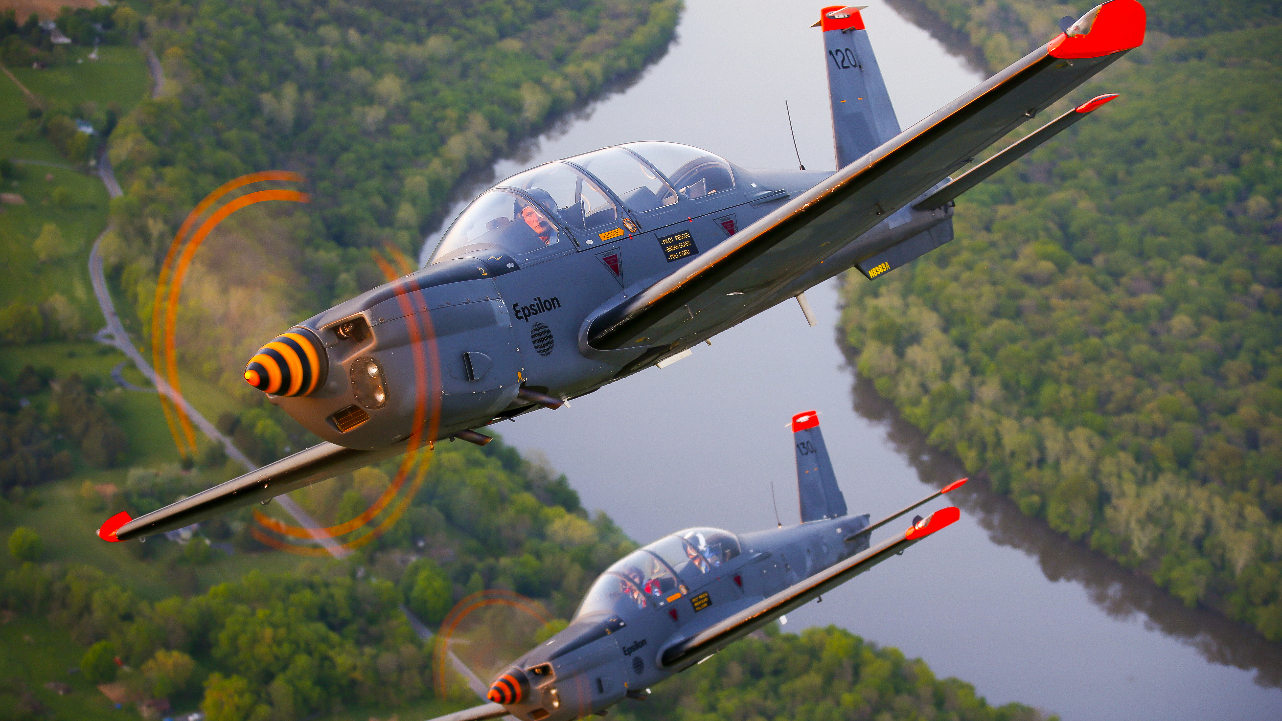 Low wings, bubble canopies, and control sticks are design features that make RV–12s, TB–30 Epsilons (pictured), and an RV–8 particularly well-suited for formation flying.