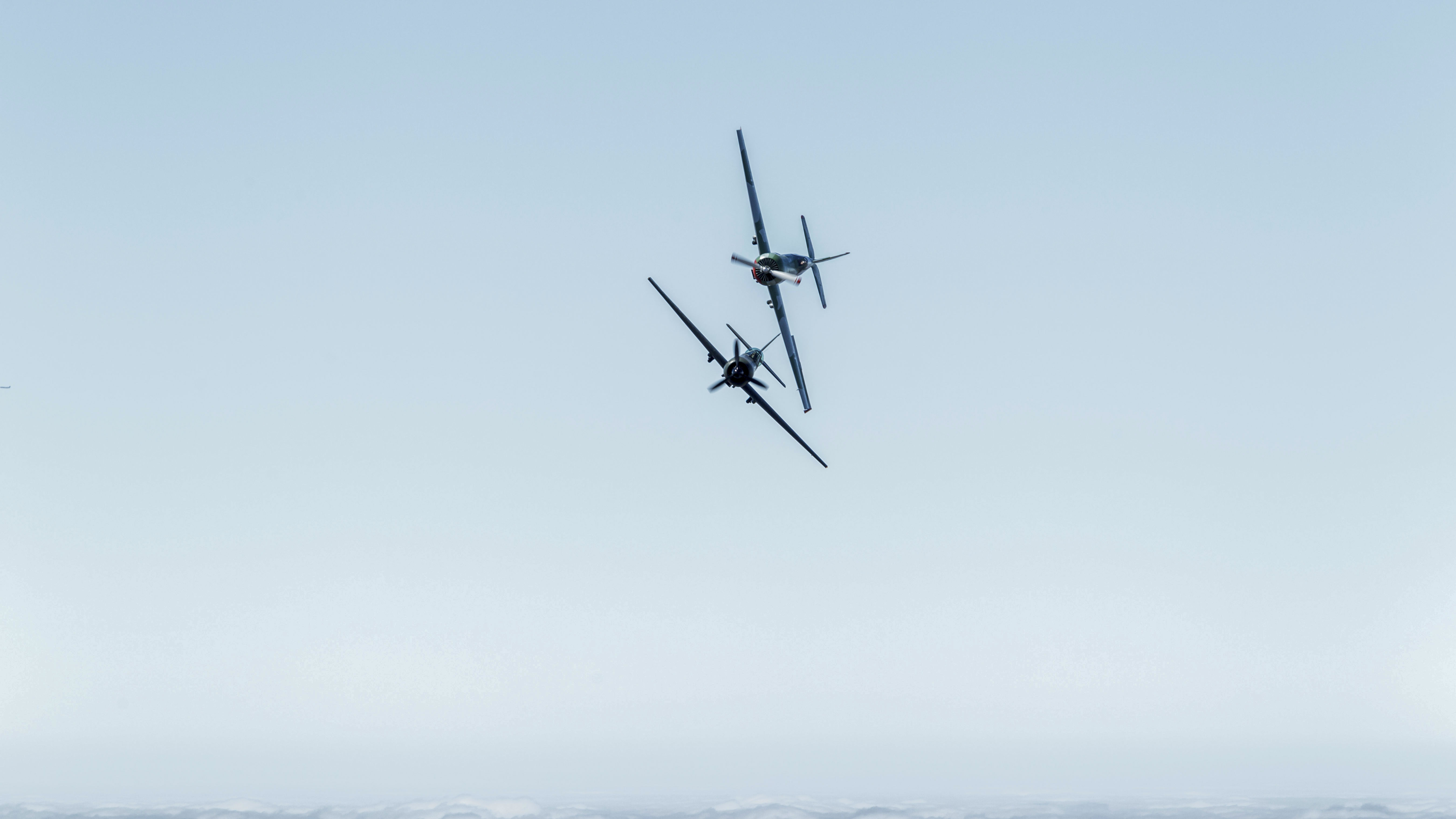 The AeroShell Aerobatic Team takes formation to a whole new level with its twilight aerobatic routine in four North American T–6 trainers, and a pair of ex-military Yak 50 pilots use formation skills during a strenuous mock dogfight over the California desert.