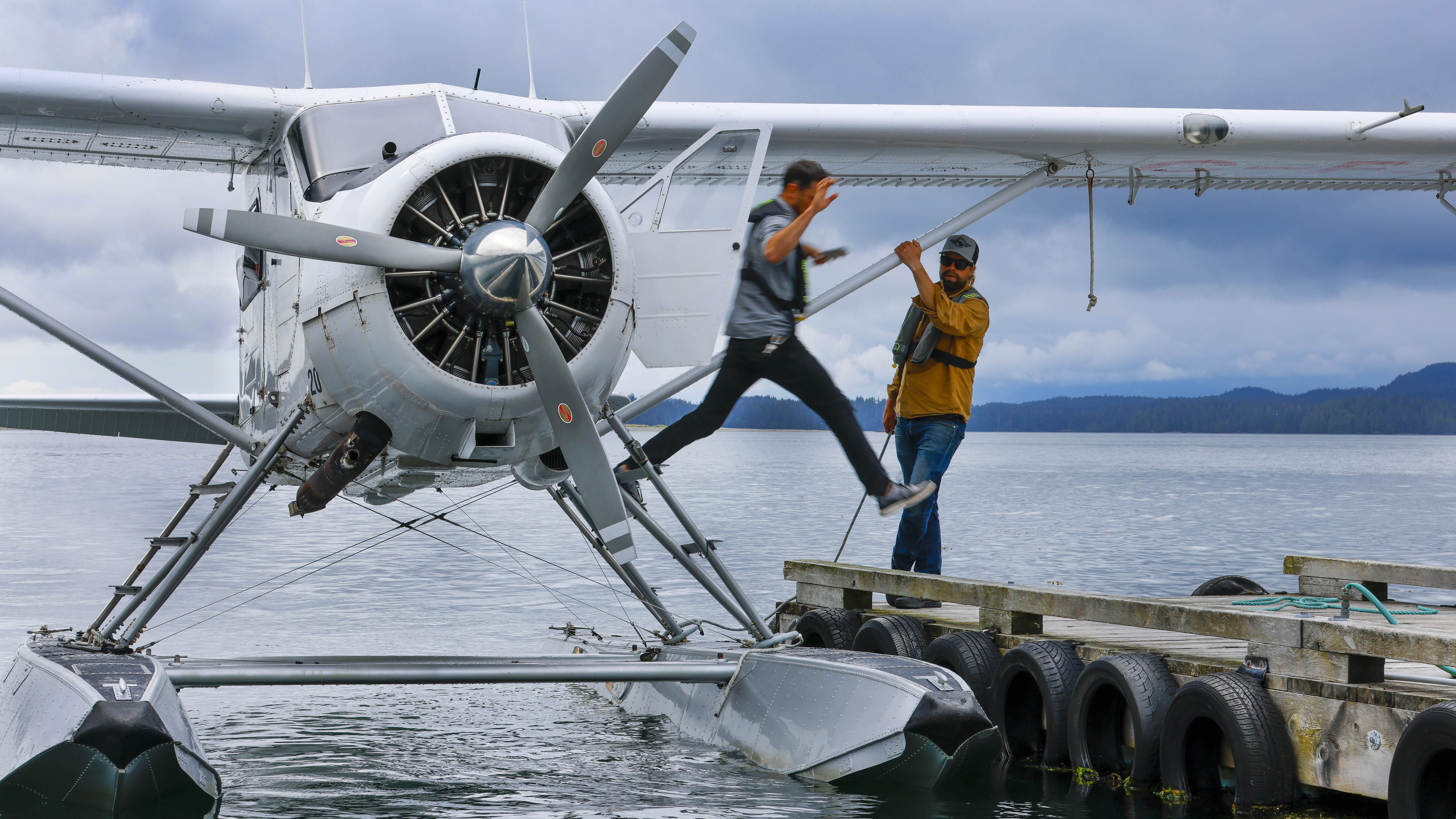 Pilot Markus Ranalla helps a passenger off the de Havilland Beaver at the Atleo dock in Clayoquot Sound.