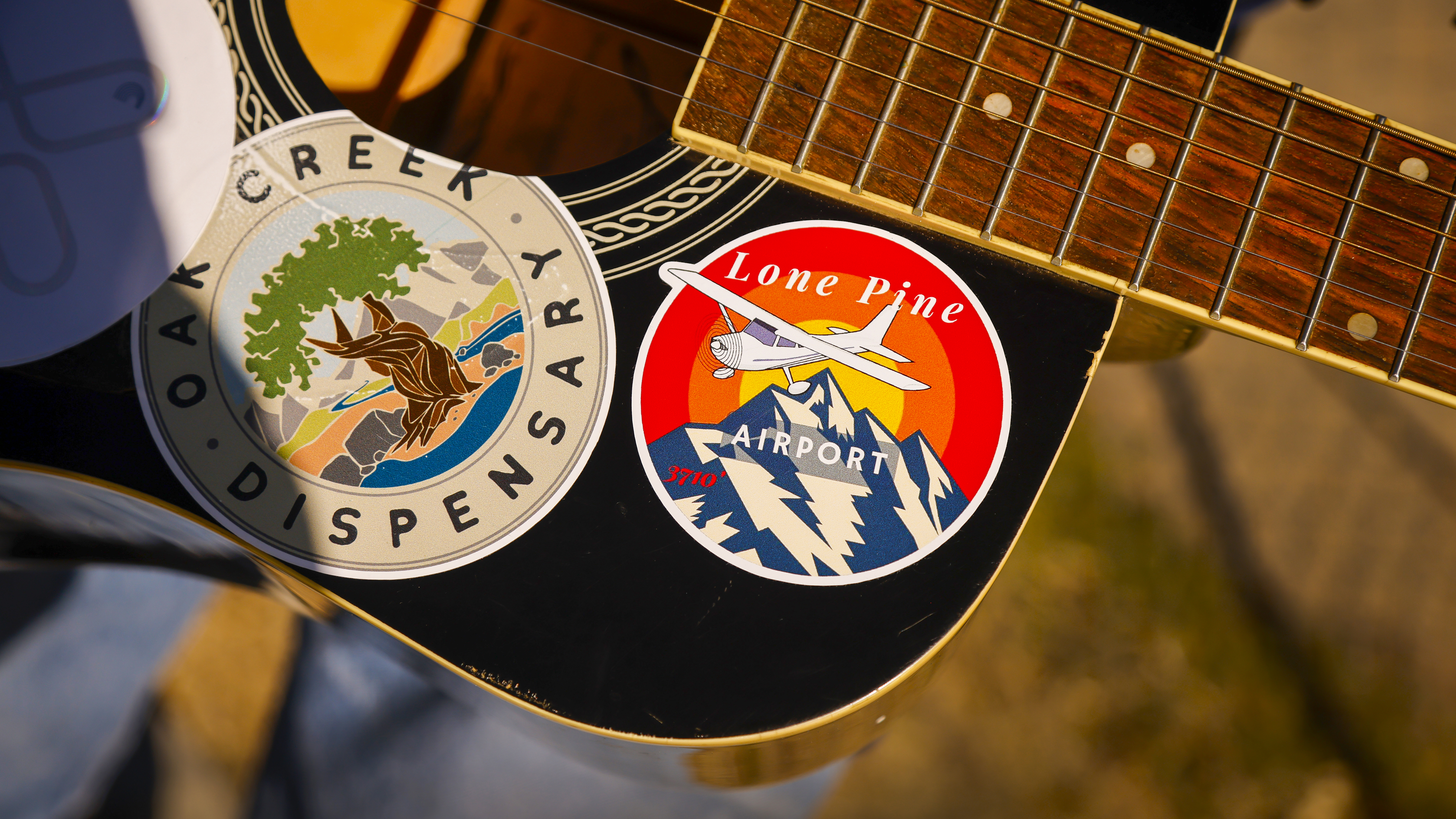 Stickers on a local's guitar.