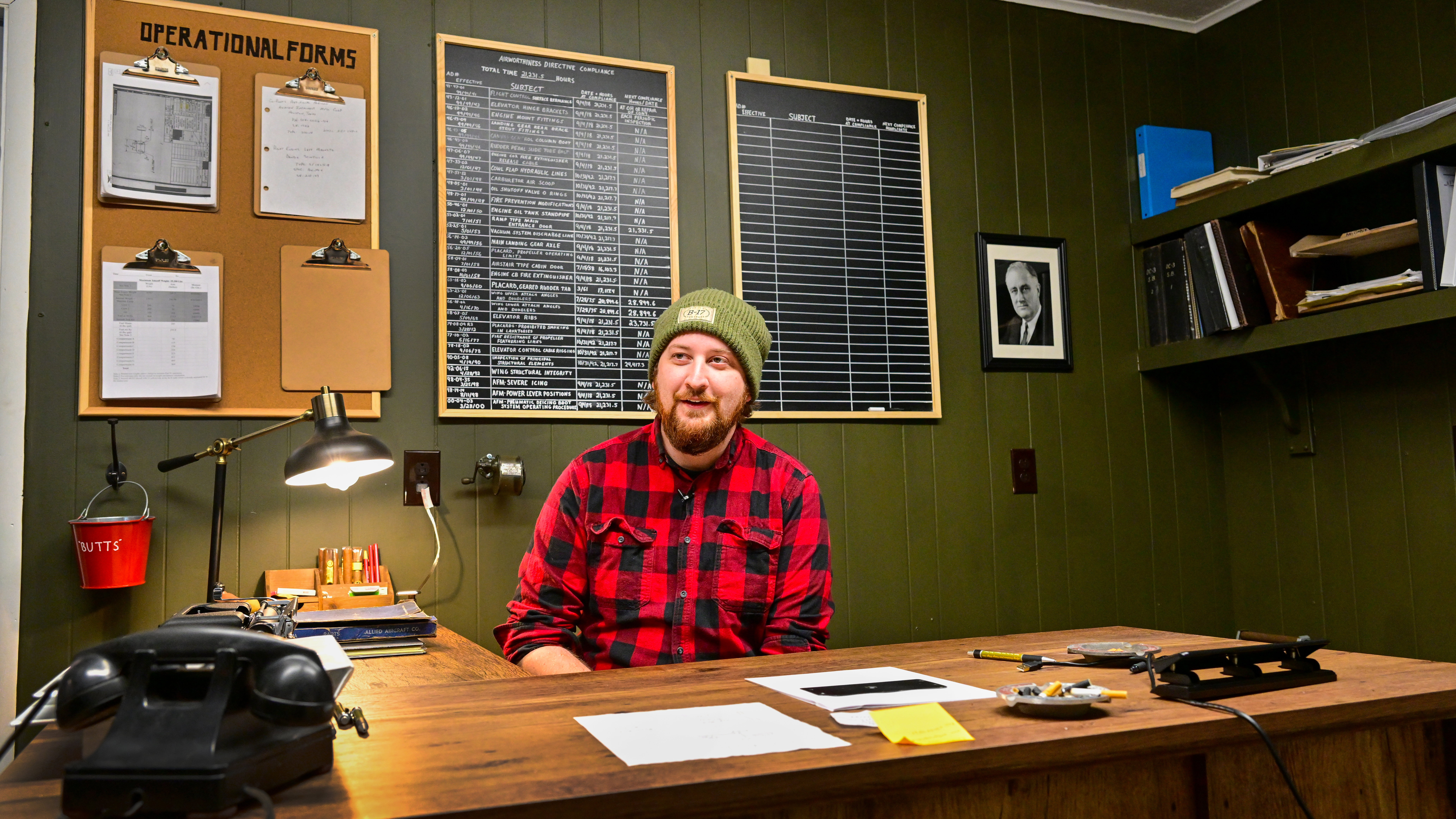 Joe Matz sits in the World War II-inspired operations office at Vintage Wings Inc.’s hangar.
