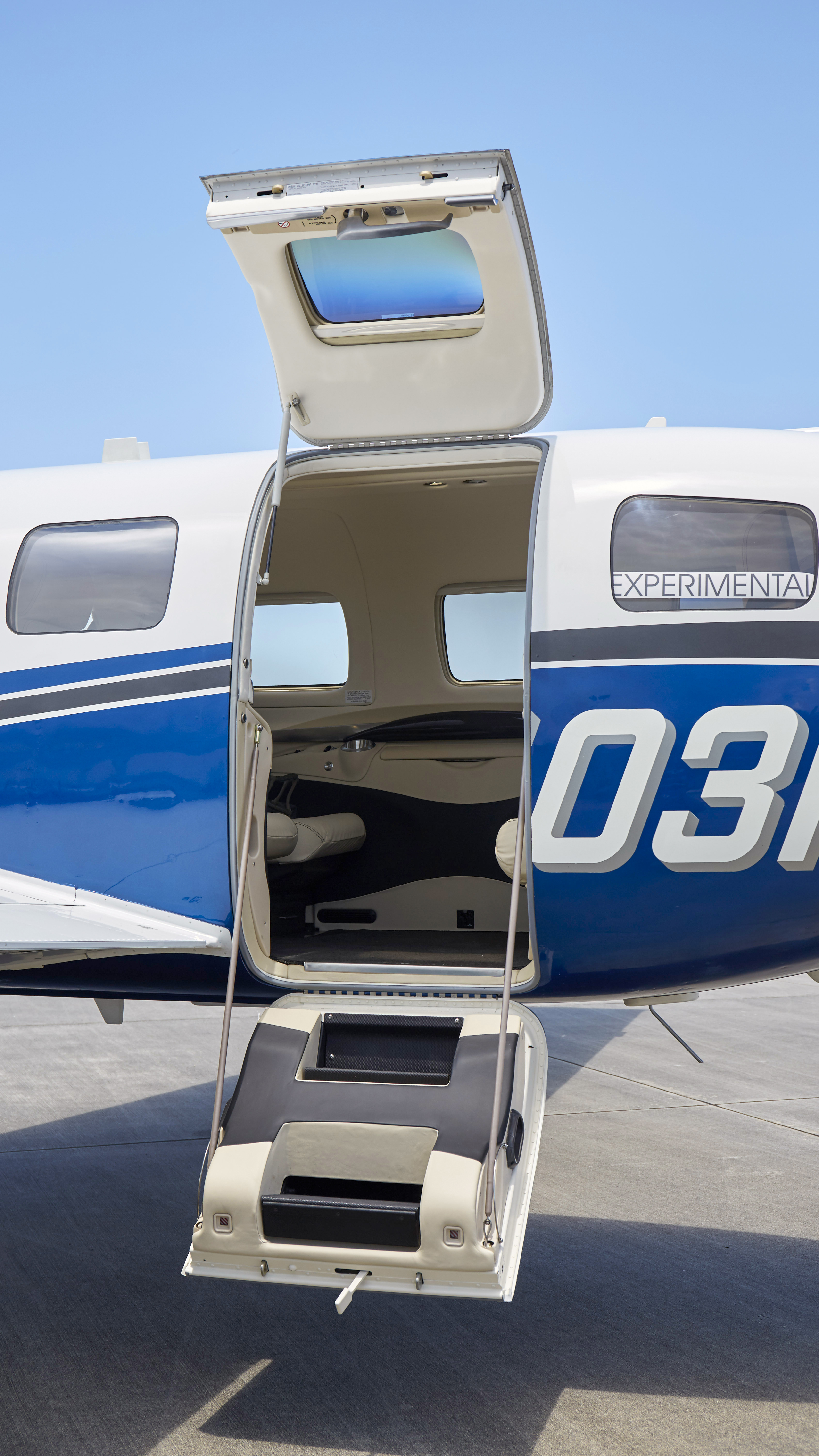 A Piper M600 clamshell aft cabin door, with cable supports.