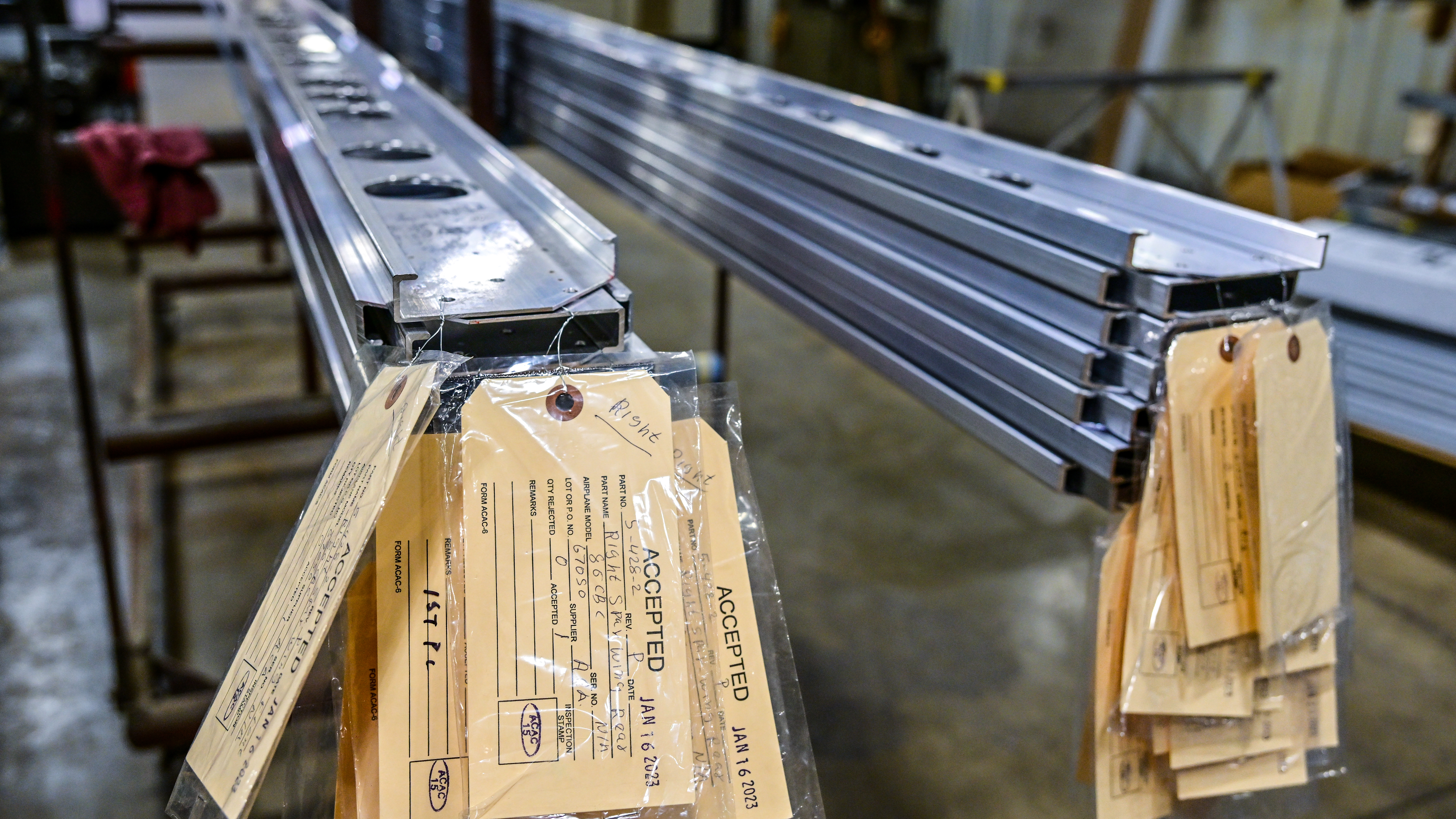 American Champion Aircraft aluminum wing spars are stacked after manufacturing in Burlington, Wisconsin. The metal spars are installed on new aircraft and on airframes undergoing conversion from the original wooden spar assembly.