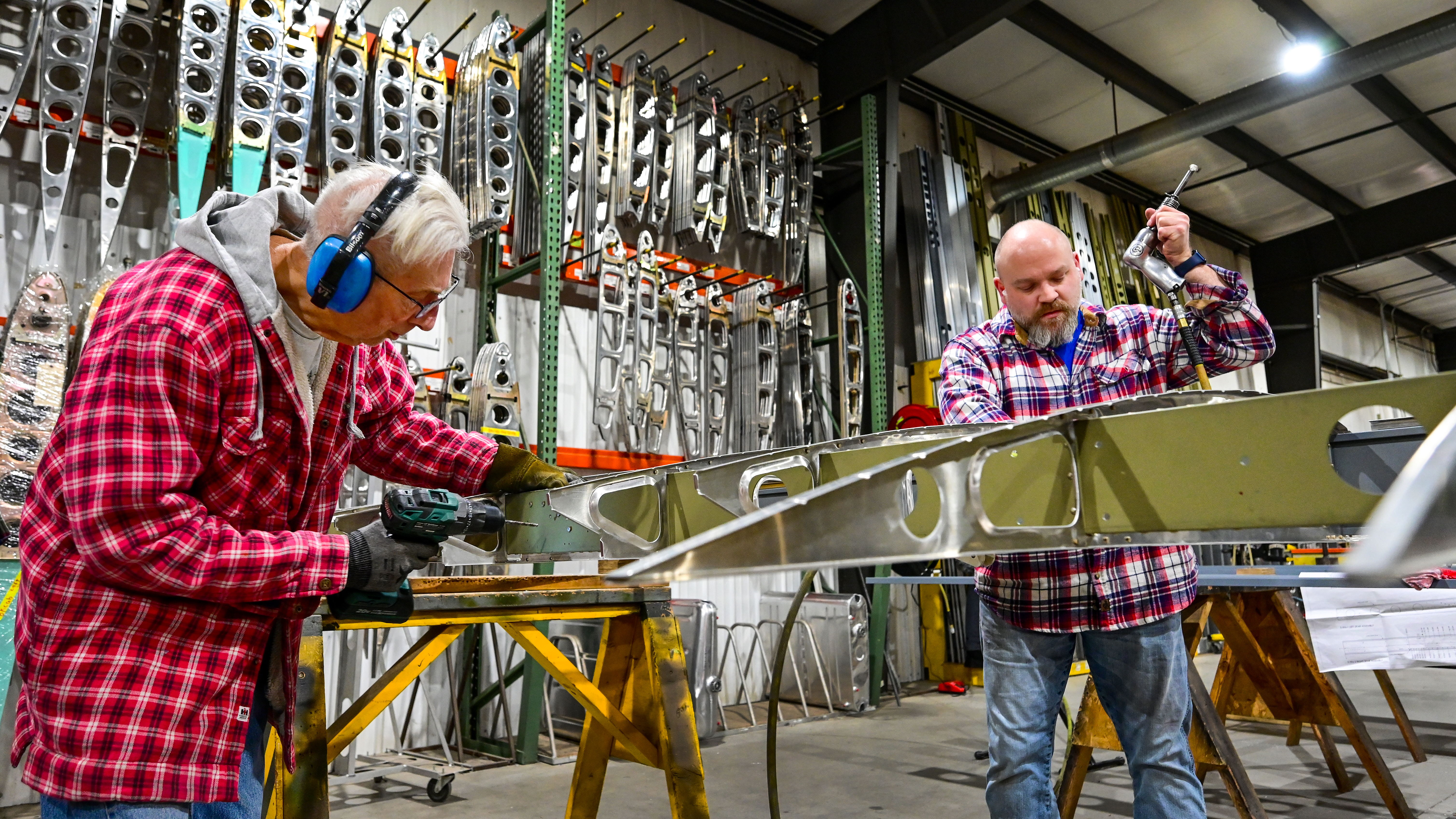 ACA employees rivet a wing assembly at the factory.