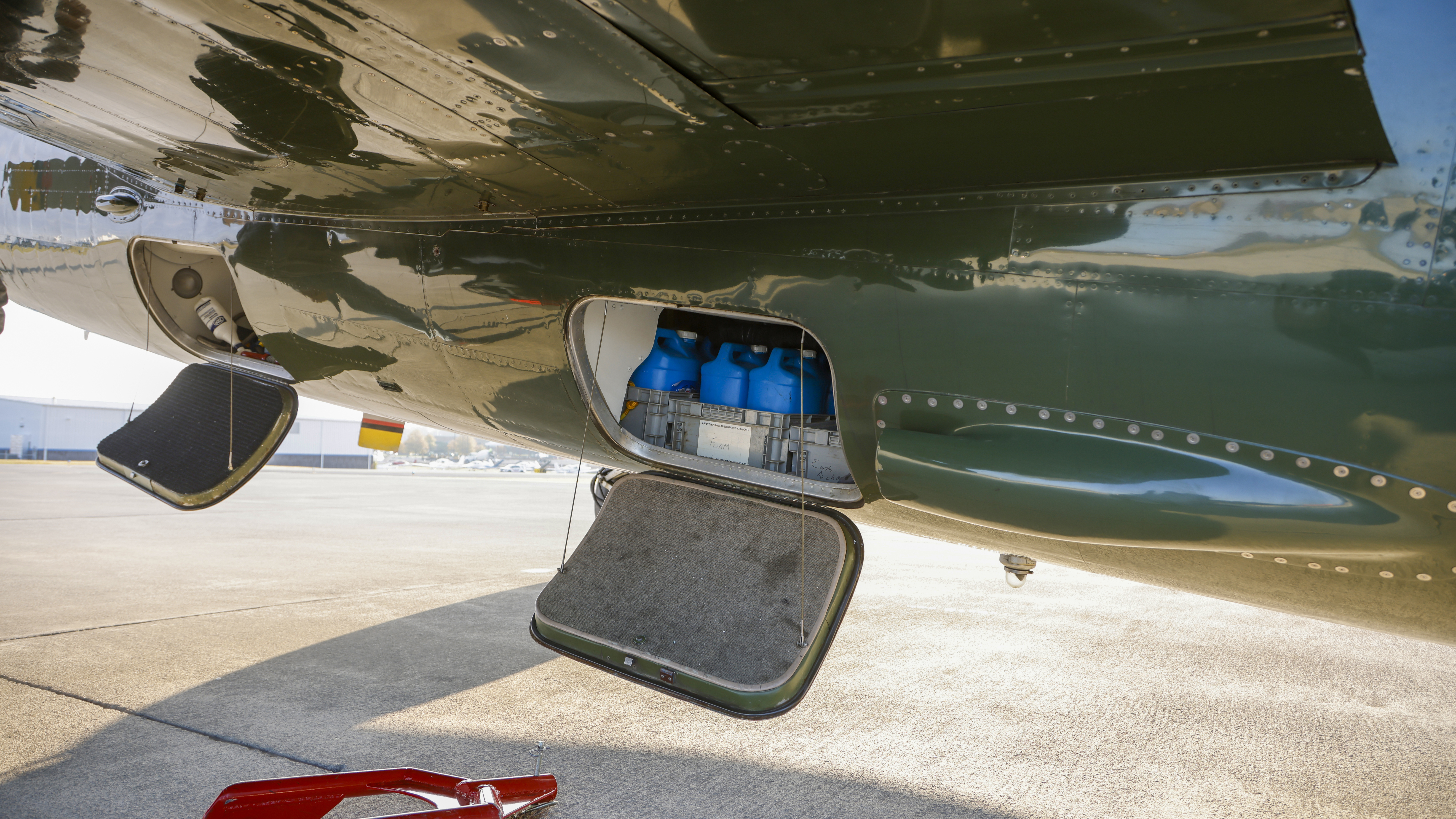Five-gallon oil containers are stored in a belly cargo compartment on trips.