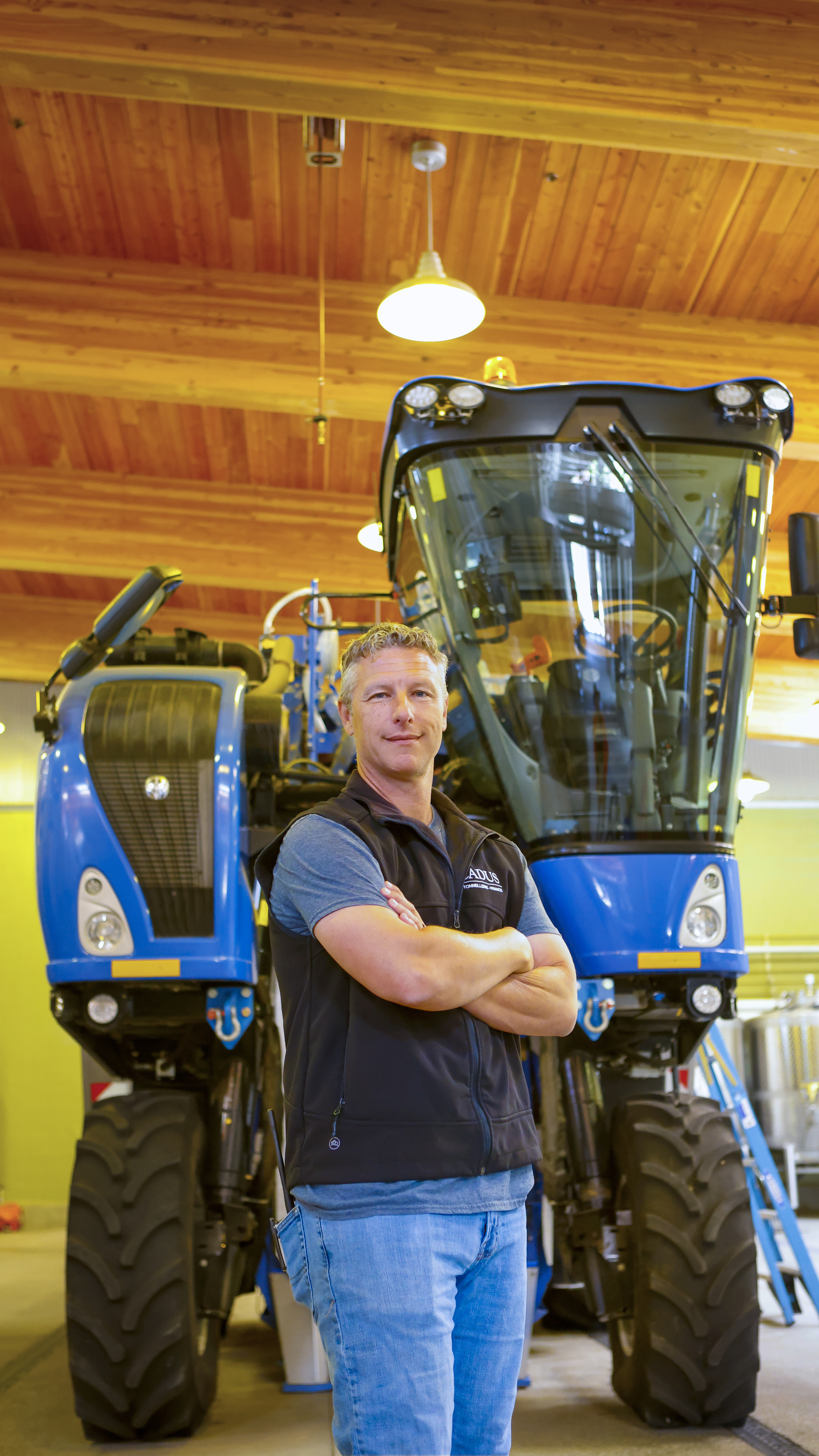 Halter Ranch’s head winemaker Kevin Sass in front of a key harvesting machine.