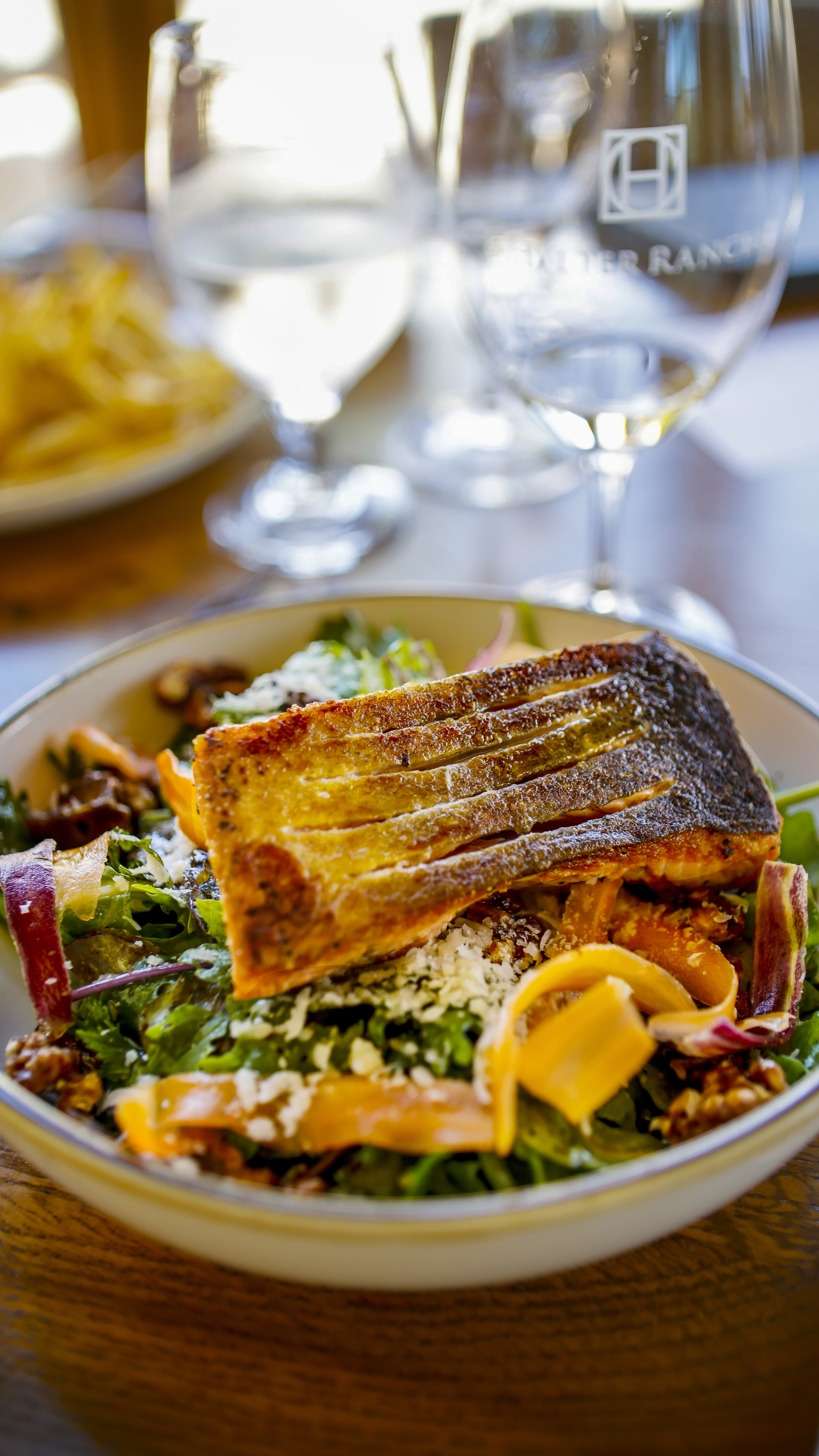 A lunch of salmon over a salad of fresh greens from the on-property Jardin du Chef.