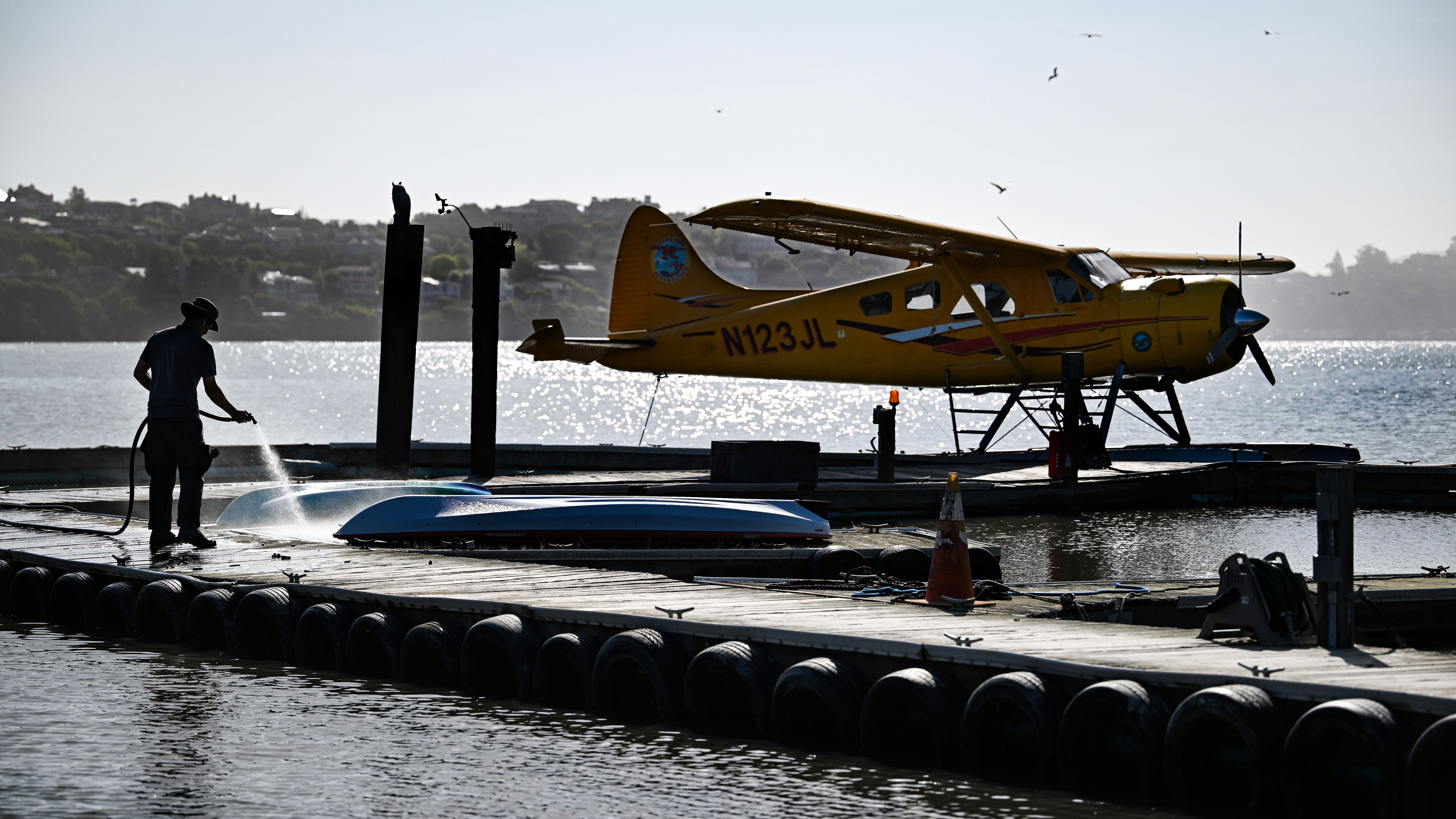 Deckhand Ren Flores begins his morning cleaning off the seaplane dock and preflighting the aircraft.