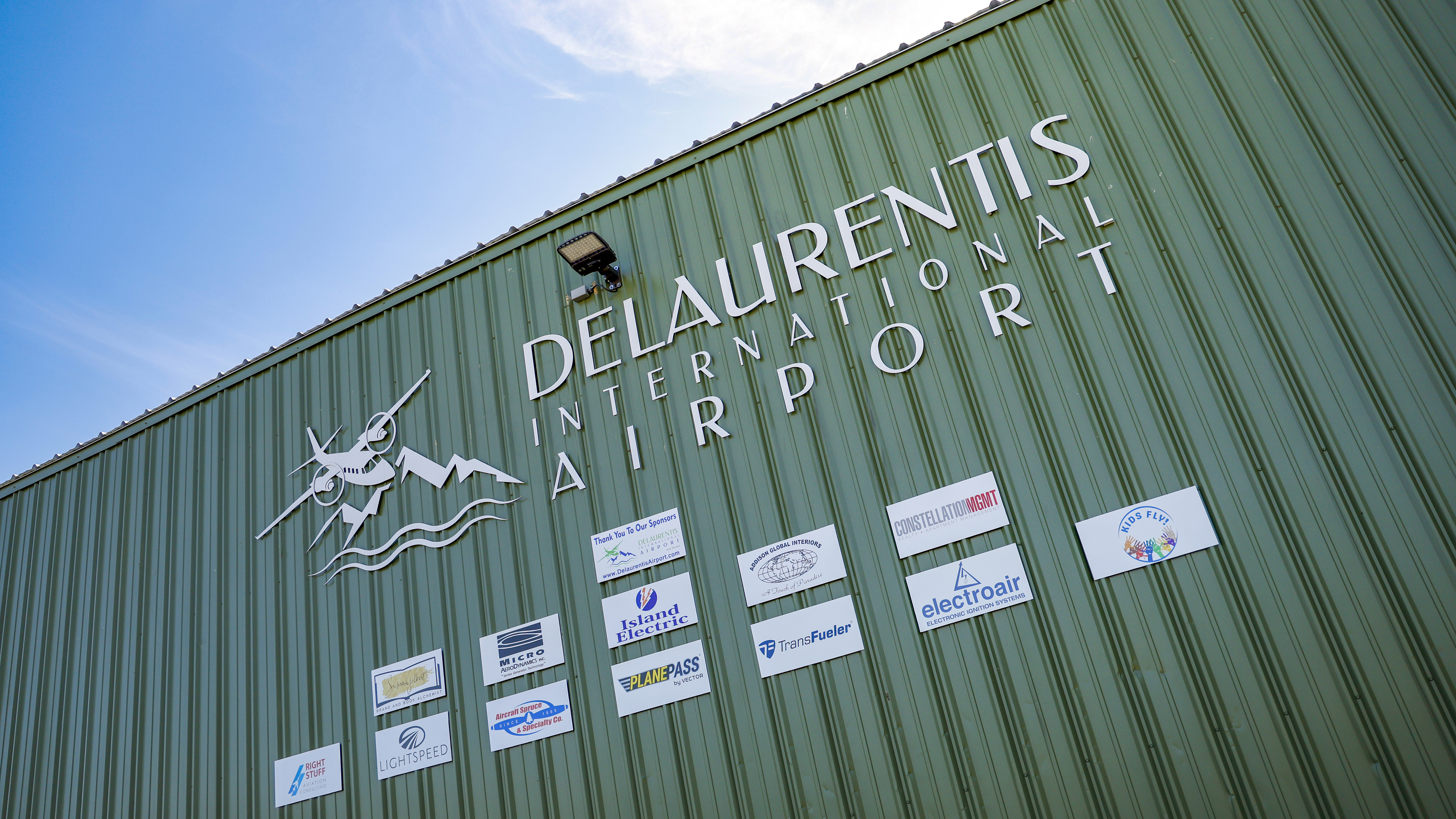 DeLaurentis makes sure his sponsors get acknowledged, displaying their logos on the side of the main hangar. 