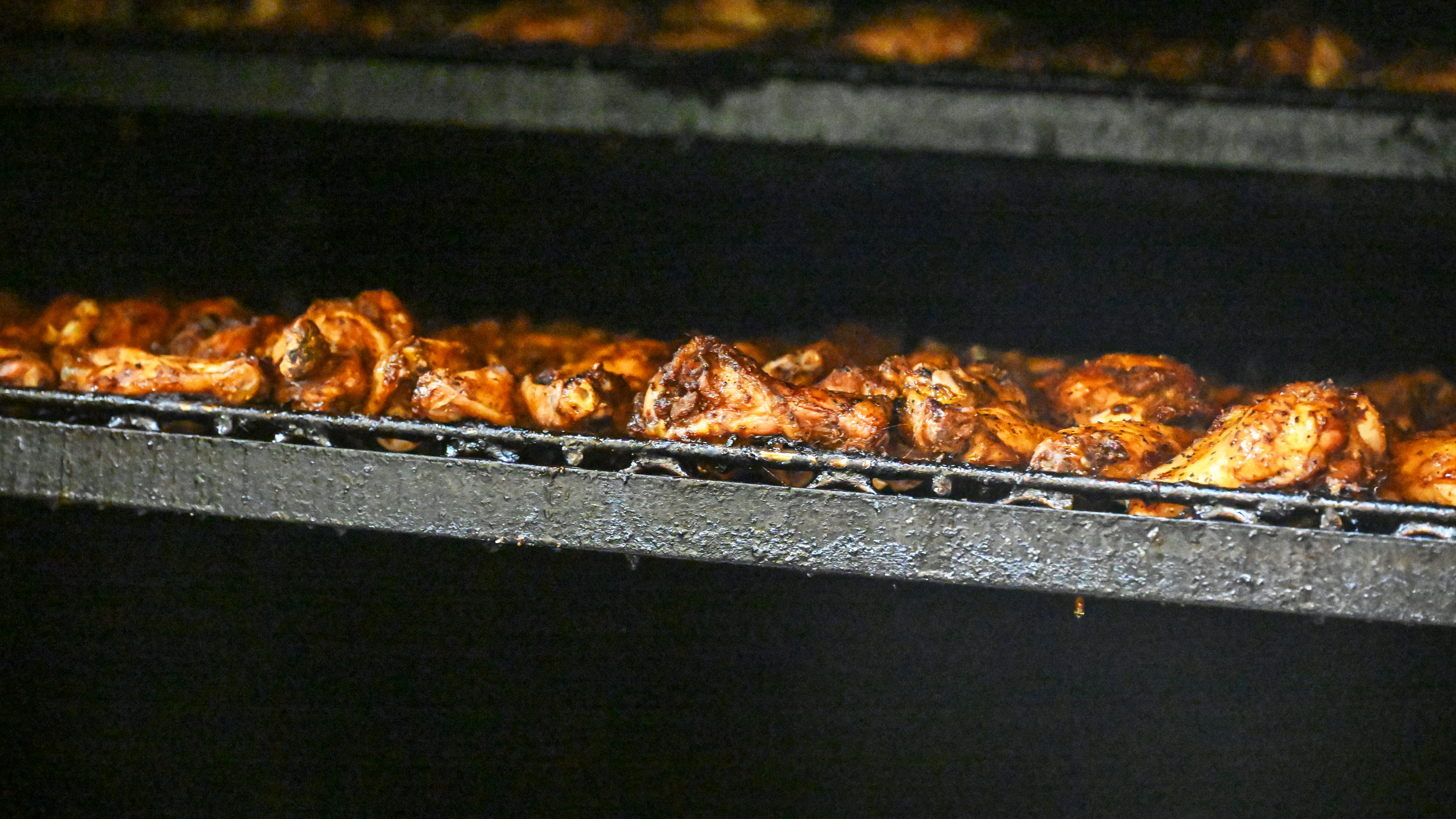 Barbecue wings in the smoker at the Aviator Smokehouse near Raleigh. Photography by David Tulis