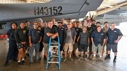 Matt Nightingale stands with his team of A&Ps, crew chiefs, and fabricators at Cal-Aerosport in Chino, California.