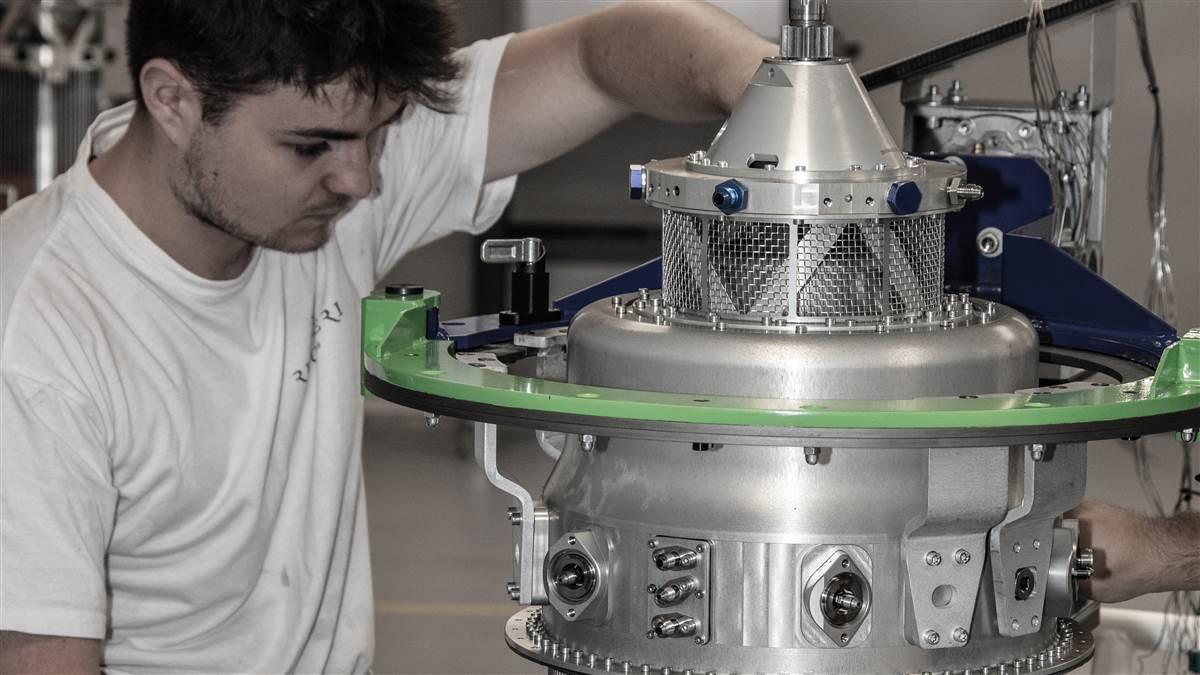 A technician assembles an R90 engine. Note the many miniature metal tubes that allow outside air to be preheated before being delivered to the combustion chamber.