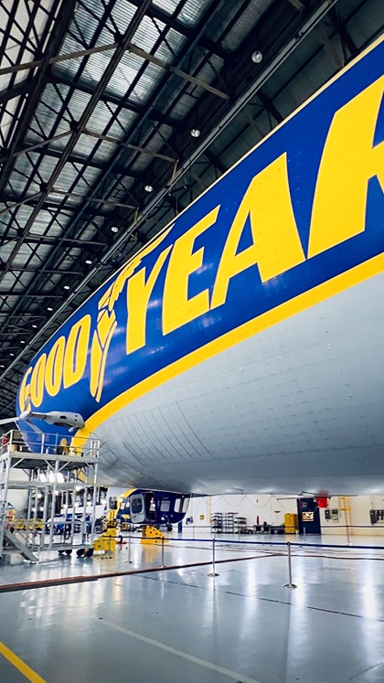 The original Goodyear blimps were nonrigid structures, which lost their shape once deflated. The helium was stored in three air bags, called ballonets, within the envelope. The Zeppelin NTs maintain their aerodynamic shape with a partially rigid frame made of aluminum and carbon fiber. The helium is stored in two ballonets. The envelope is made of a three-layered laminate, one of which acts as a gas barrier. The outer layer is UV protected and keeps the sun out and the helium cool.