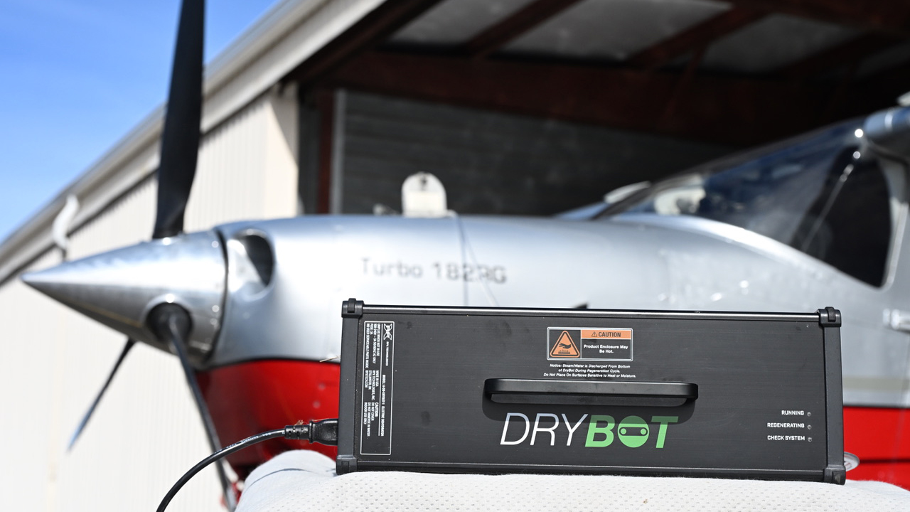 The DryBot automated engine dehumidifier features inflow and outflow monitoring of air, a liquid silica desiccant that extracts moisture from the air before it enters the engine, and automated drying of the desiccant.