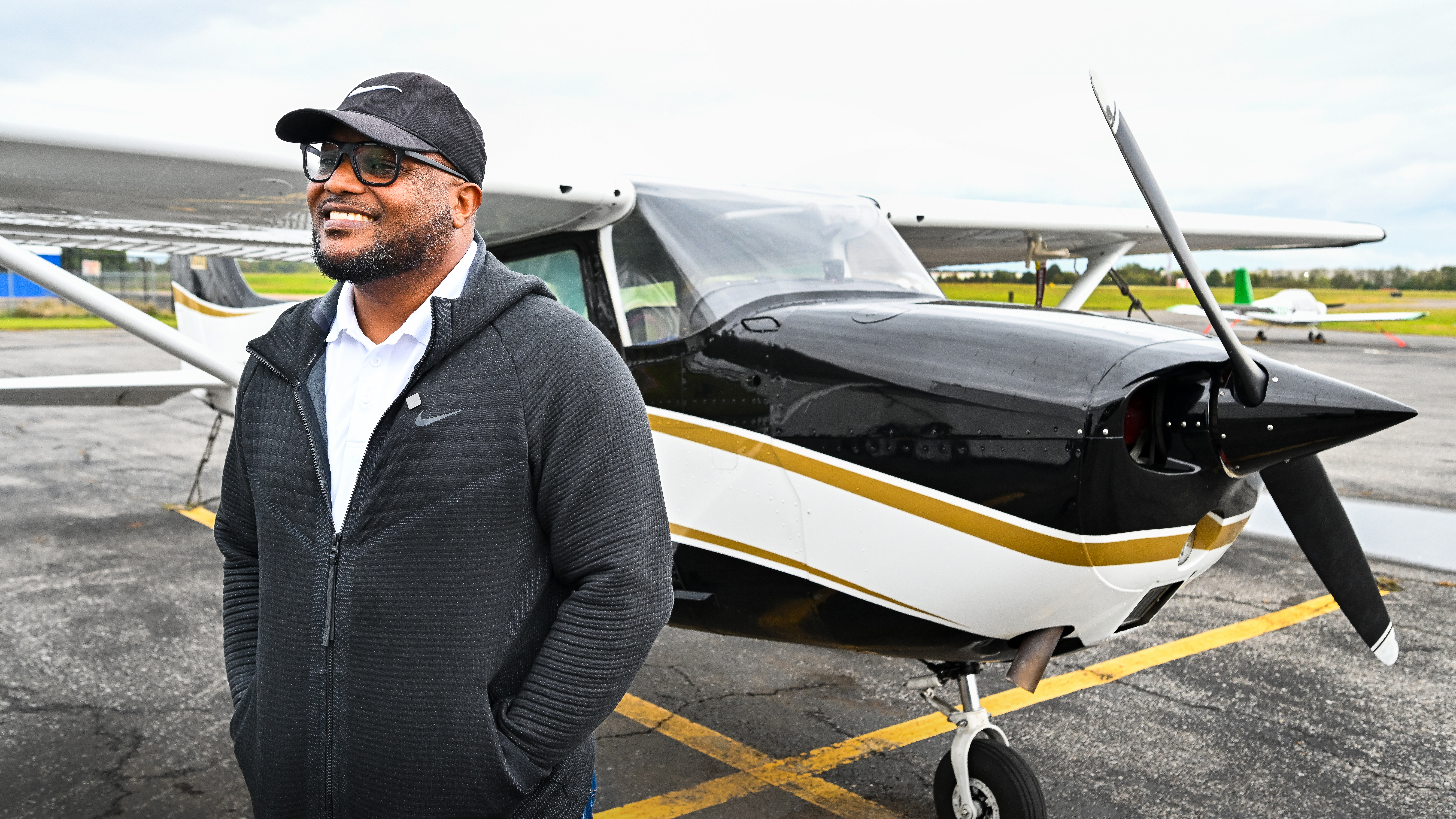 Mike Anderson stands in front of a Dynon-equipped, freshly painted Cessna 172 in an OBAP livery.