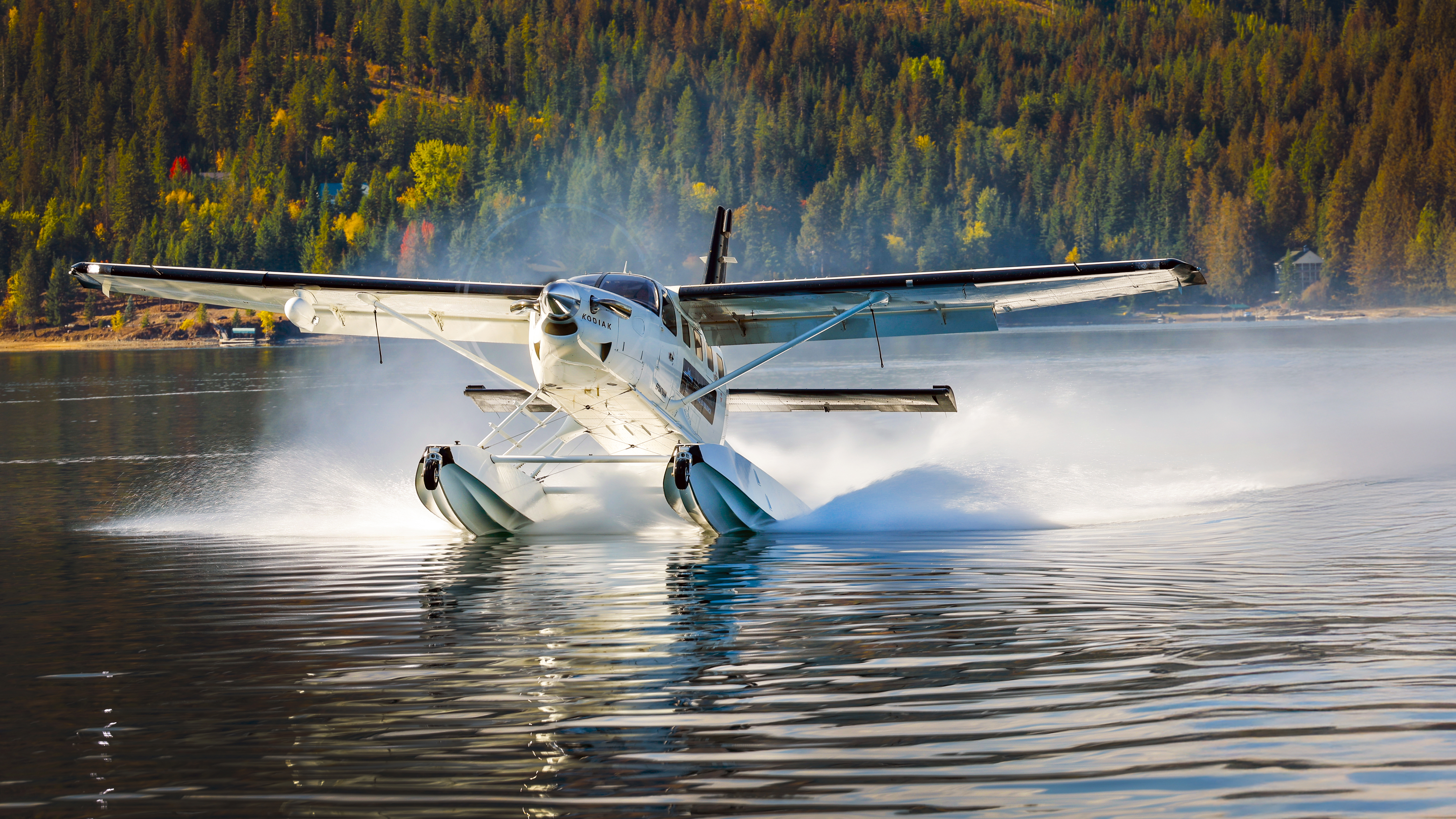 The float Kodiak's graceful takeoff on a calm morning at the lake.
