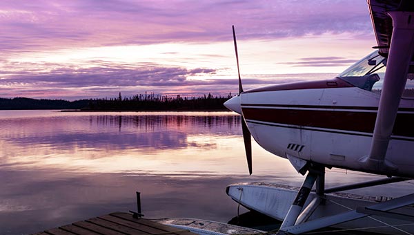 Seaplane on lake at sunset