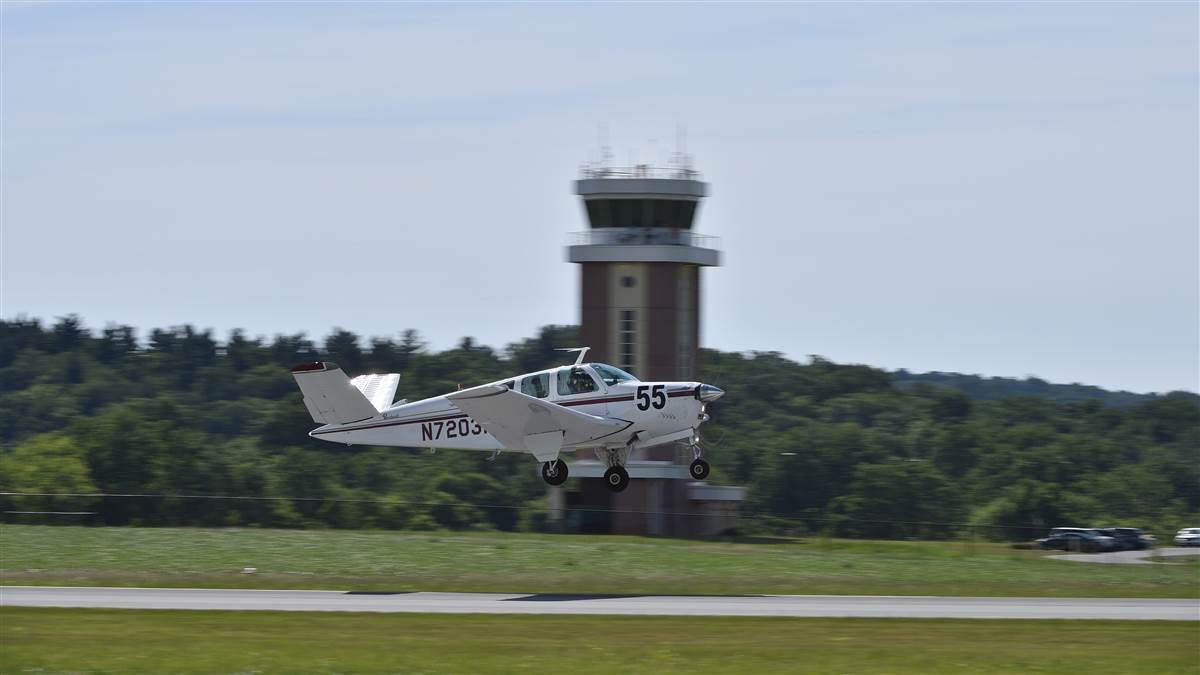 Aerobatic performer Debby Rihn-Harvey and pilot Chris Dale in the No. 55 V-tail Bonanza rotate near the control tower to begin the four-day, 14-state cross-country Air Race Classic all-female competition, June 20. Photo by David Tulis.