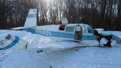 aftermath of a piper that crashed into a snowy bank