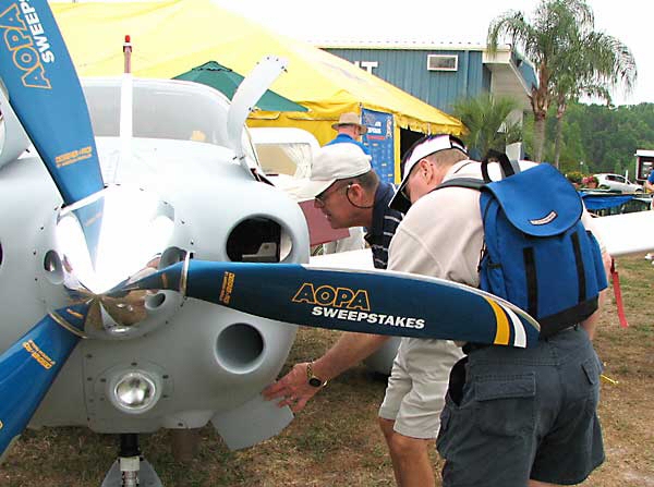 Early birds at Sun 'n Fun get first look at the AOPA Sweepstakes aircraft, tied down in front of the Big Yellow Tent.