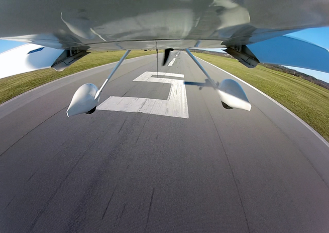 Partial flaps with the upwind wing held low help counter a crosswind blowing from left to right on this landing.