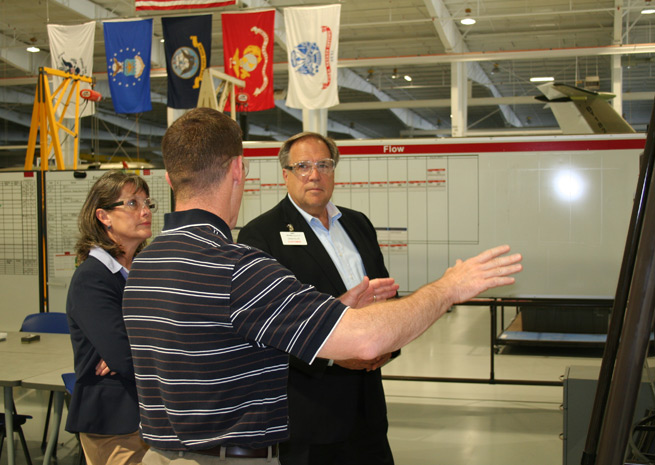 AOPA Vice President of Advertising Carol Dodds and AOPA President Craig Fuller get a briefing from John F. (Cub) Marion, Beechcraft Corp. senior vice president of global manufacturing. Photo courtesy of Beechcraft.