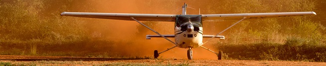 A Cessna 182 kicks up red Tsavo dust in Kilaguni.