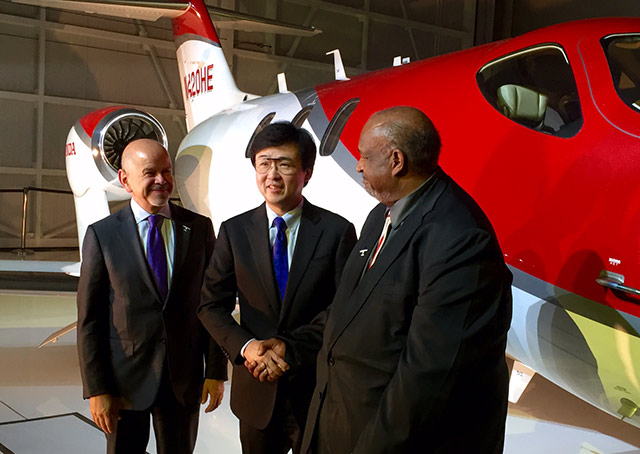 FAA Administrator Michael Huerta looks on as Melvin Taylor (right), manager of the FAA's Atlanta Aircraft Certification Office, congratulates Michimasa Fujino, president and CEO of Honda Aircraft, upon receipt of the type certificate for the HondaJet on Dec. 9.