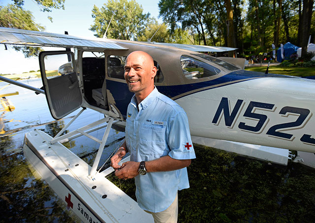 Samaritan Aviation's Mark Palm talks about his role with the nonprofit organization next to its newly acquired Cessna U206G float plane at the Seaplane Base. Photo by David Tulis.